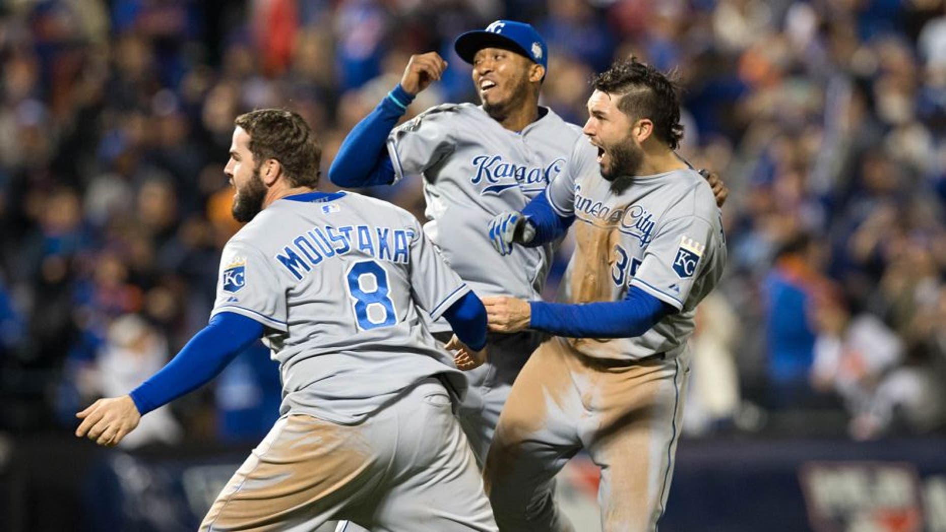 NEW YORK, NY - NOVEMBER 1: Mike Moustakas #8, Eric Hosmer #35 and Alcides Escobar #2 of the Kansas City Royals celebrate on the field after defeating the New York Mets in Game 5 of the 2015 World Series at Citi Field on Sunday, November 1, 2015 in the Queens borough of New York City. (Photo by Rob Tringali/MLB Photos via Getty Images)