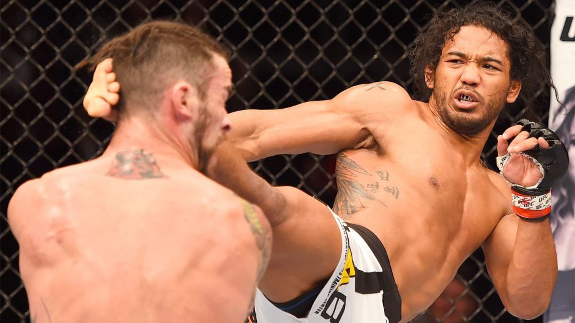 BROOMFIELD, CO - FEBRUARY 14: (R-L) Benson Henderson lands a kick to the head of Brandon Thatch in their welterweight fight during the UFC Fight Night event inside 1stBank Center on February 14, 2015 in Broomfield, Colorado. (Photo by Josh Hedges/Zuffa LLC/Zuffa LLC via Getty Images)