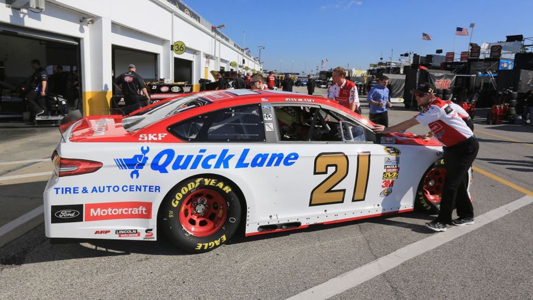 DAYTONA BEACH, FL - FEBRUARY 13: The car of Ryan Blaney (not pictured), driver of the #21 Motorcraft/Quick Lane Tire & Auto Center Ford, is pushed by crew members through the garage area during practice for the NASCAR Sprint Cup Series Daytona 500 at Daytona International Speedway on February 13, 2016 in Daytona Beach, Florida. (Photo by Jerry Markland/Getty Images)