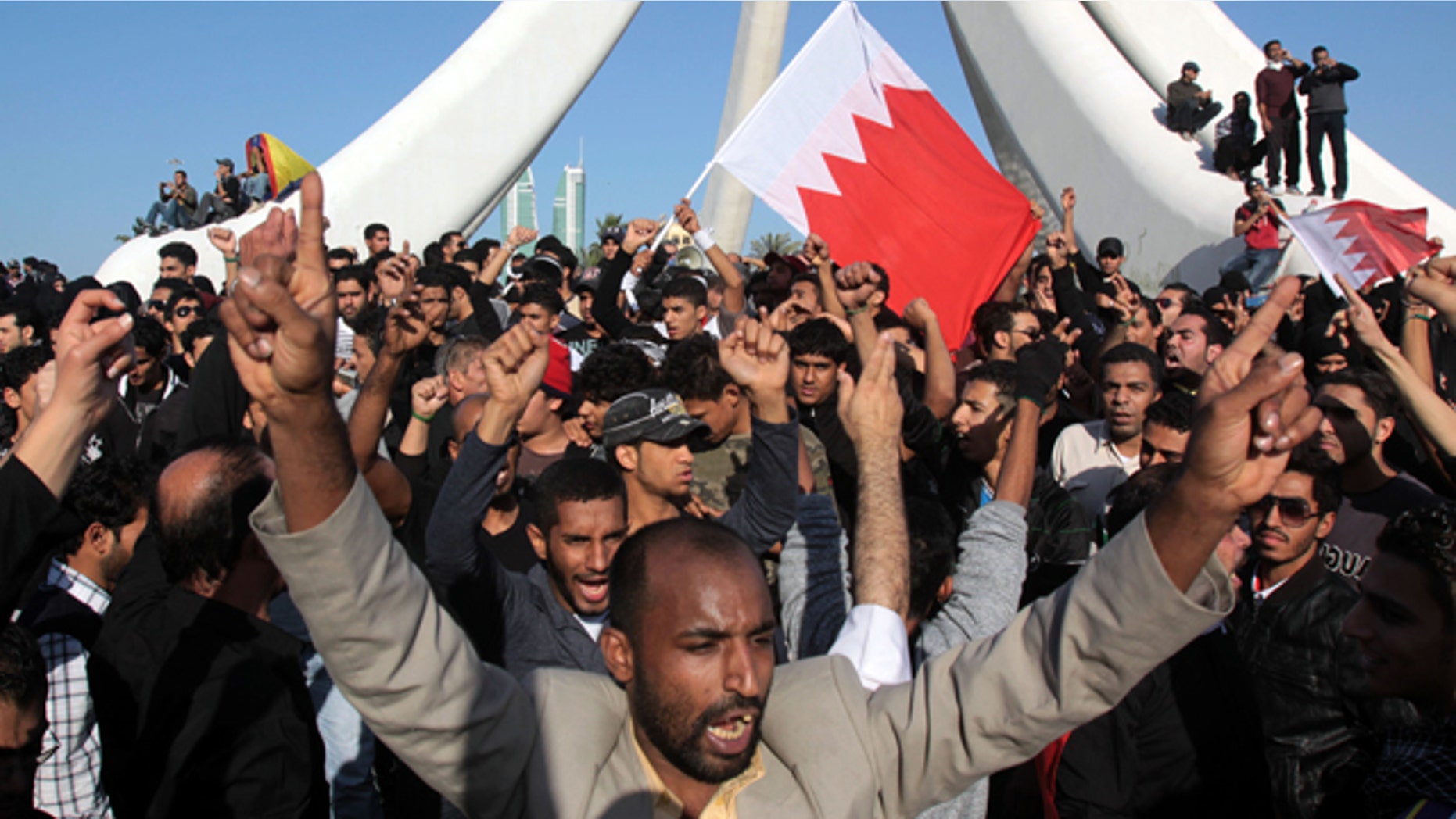 Feb. 15: Demonstrators chant and wave Bahraini flags near the Pearl Monument on a main square in Manama, Bahrain.