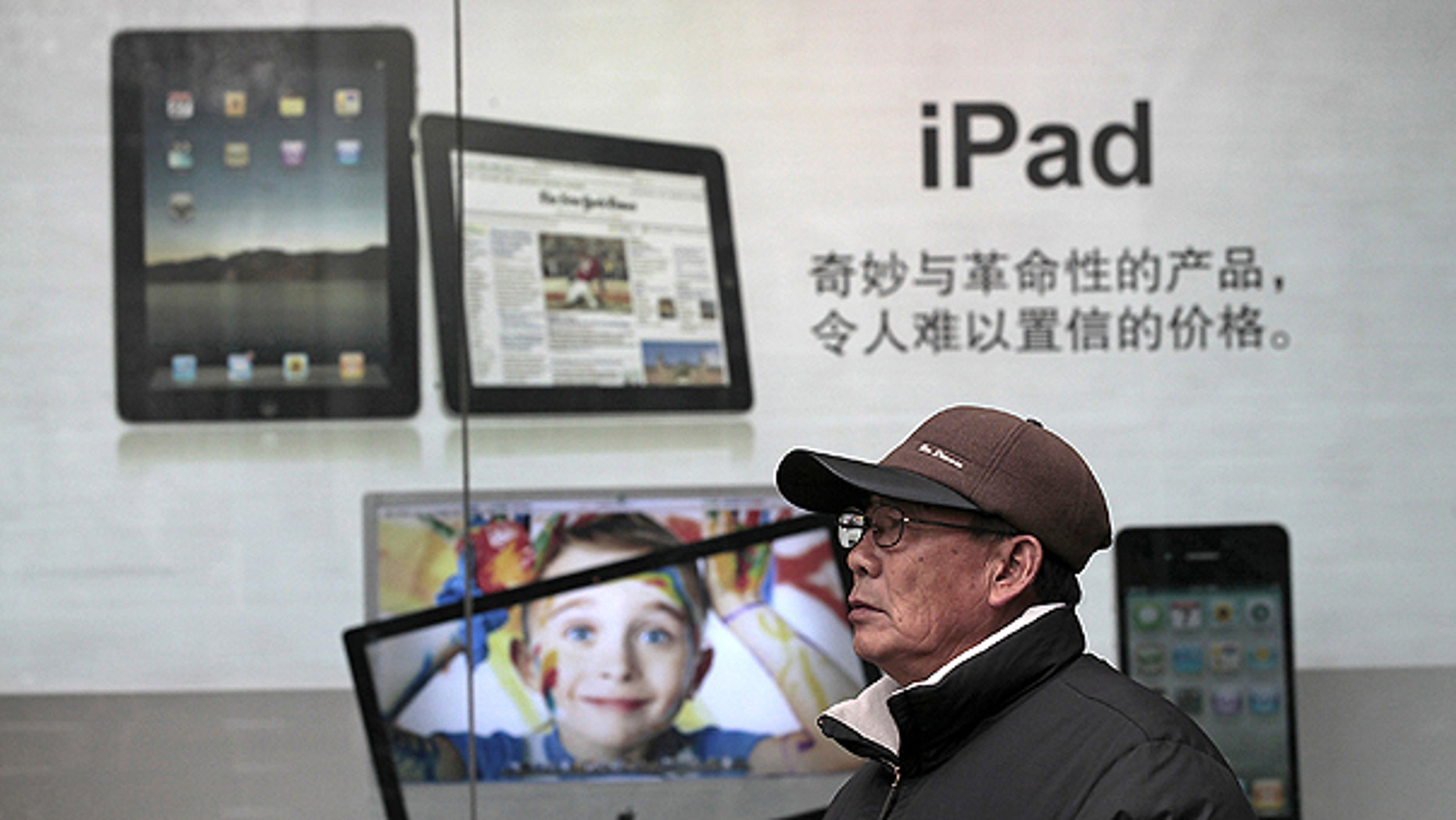 Jan. 26: A man stands near Apple's iPad advertisement in Shanghai, China.