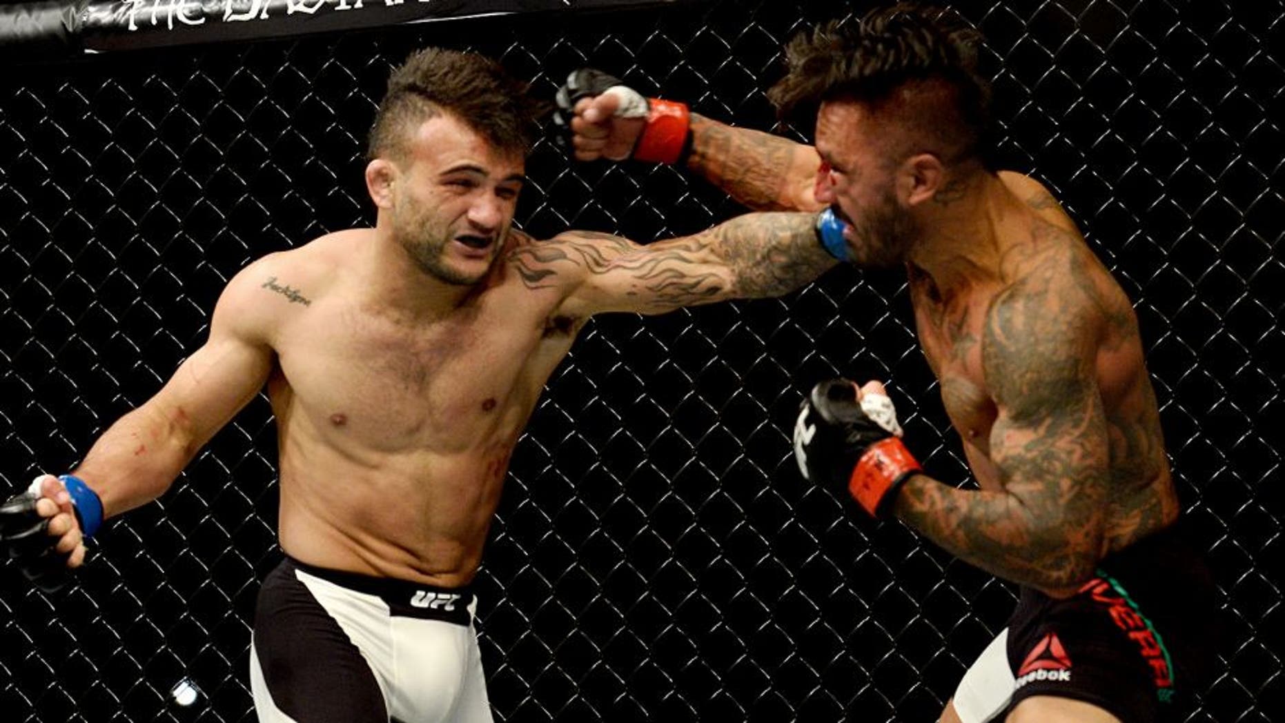 LAS VEGAS, NV - SEPTEMBER 05: (L-R) John Lineker punches Francisco Rivera in their bantamweight bout during the UFC 191 event inside MGM Grand Garden Arena on September 5, 2015 in Las Vegas, Nevada. (Photo by Brandon Magnus/Zuffa LLC/Zuffa LLC via Getty Images)