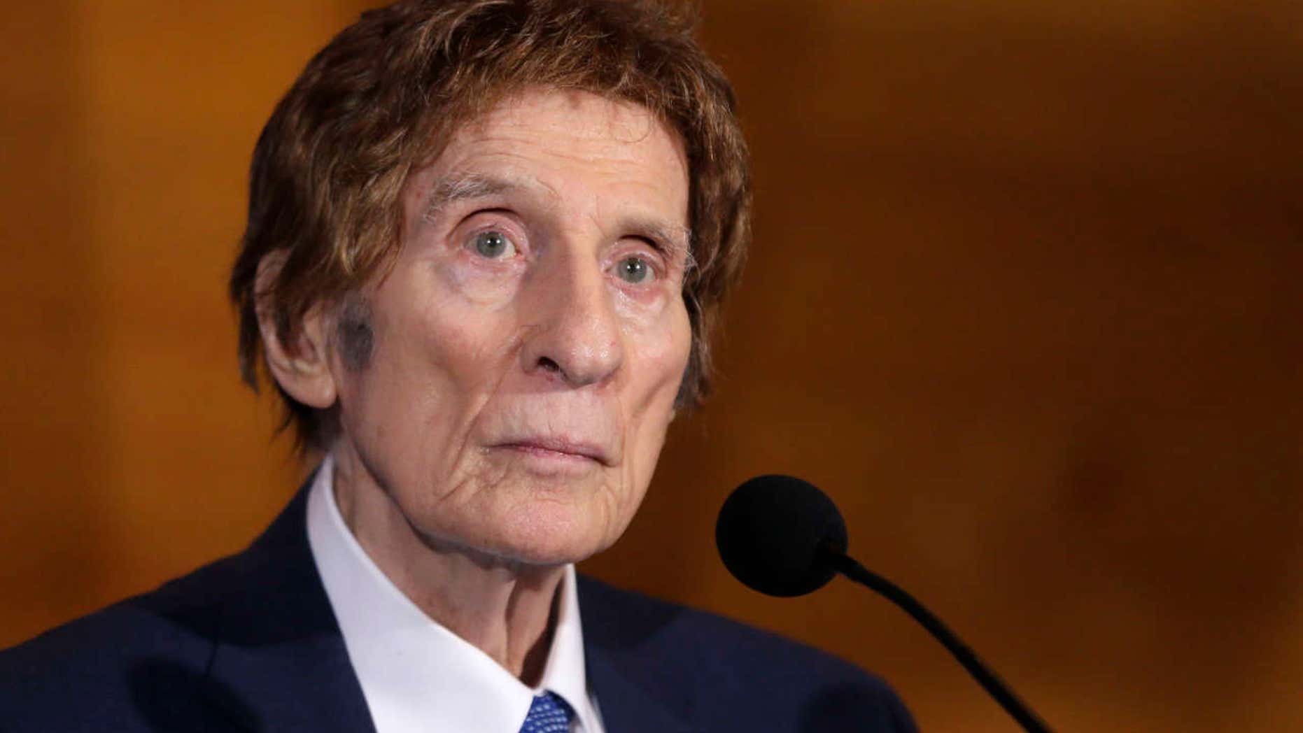 FILE- In a file photo from Nov. 14, 2014, Detroit Tigers owner Mike Ilitch listens during a news conference in Detroit. Ilitch, the owner of the Detroit Red Wings and Tigers, who founded the Little Caesars Pizza empire, has died.