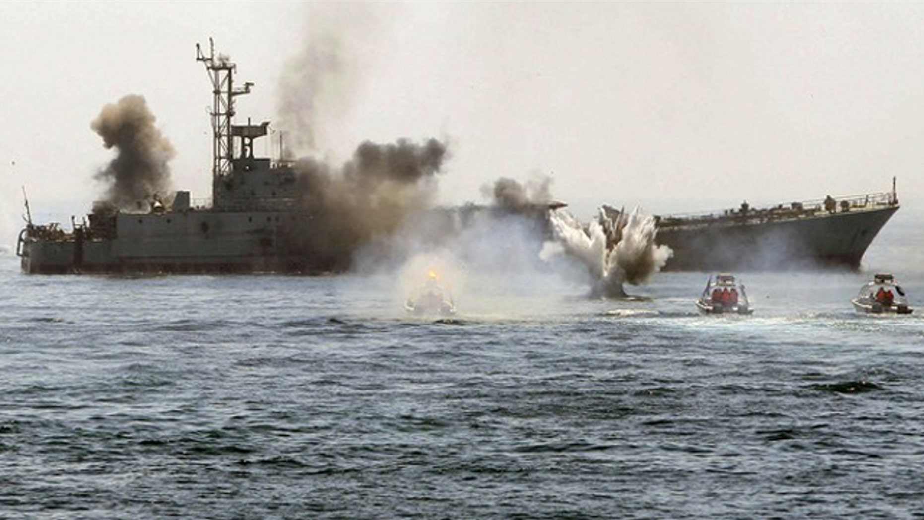 An Iranian warship and speed boats take part in a naval war game in the Persian Gulf and the Strait of Hormuz, southern Iran on April 22, 2010.
