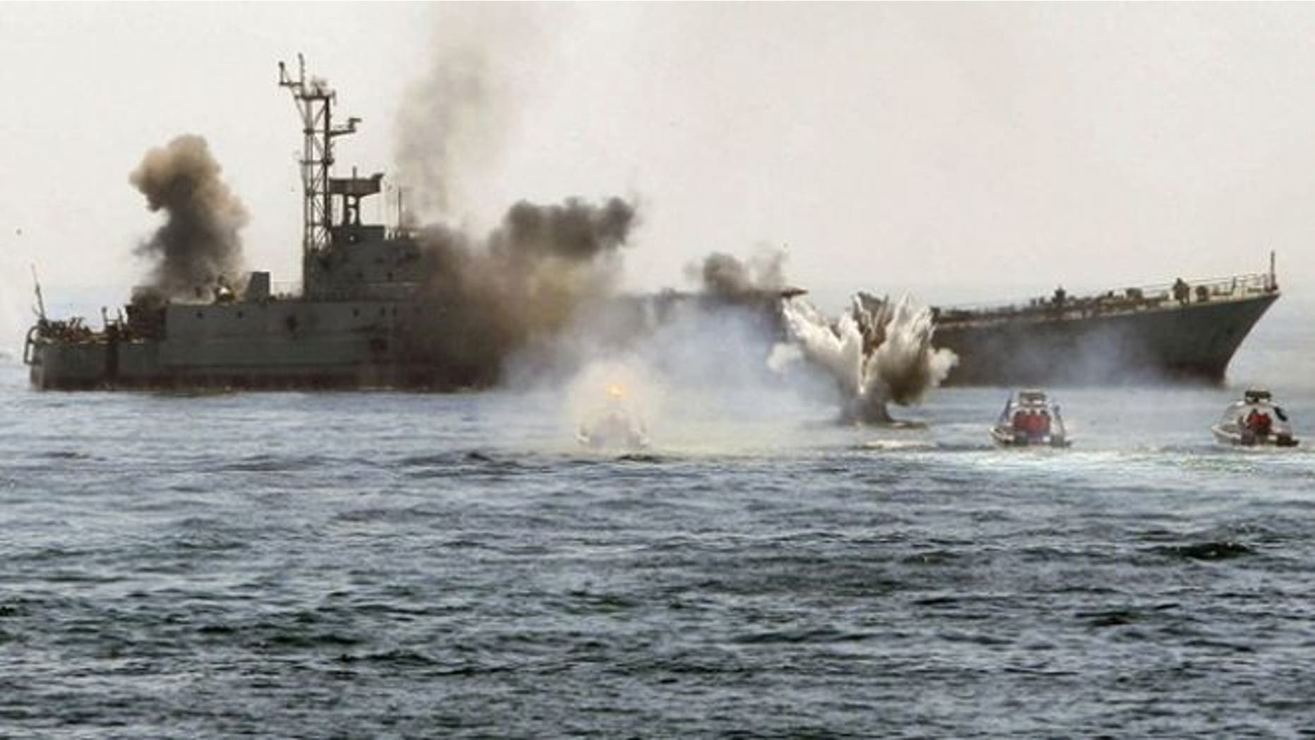 April 22, 2010: An Iranian warship and speed boats take part in a naval war game in the Persian Gulf and the Strait of Hormuz, southern Iran. (Reuters)