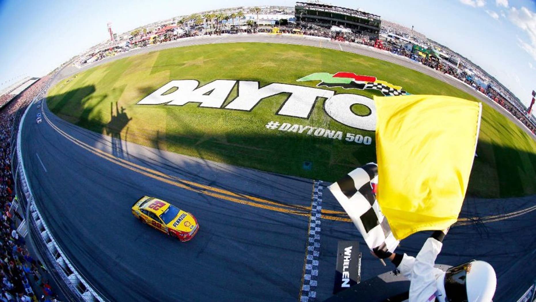 DAYTONA BEACH, FL - FEBRUARY 22: Joey Logano, driver of the #22 Shell Pennzoil Ford, takes the checkered flag to win the NASCAR Sprint Cup Series 57th Annual Daytona 500 at Daytona International Speedway on February 22, 2015 in Daytona Beach, Florida. (Photo by Jonathan Ferrey/NASCAR via Getty Images)