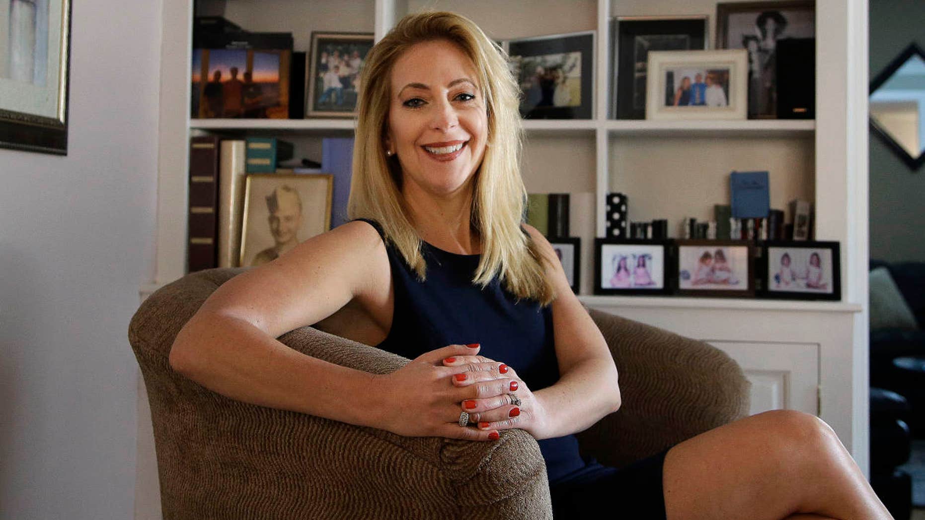 In this Tuesday, Feb. 14, 2017 photo former Tiffany & Co. employee Lisa O'Rourke sits for a portrait in her home in North Kingstown, R.I.