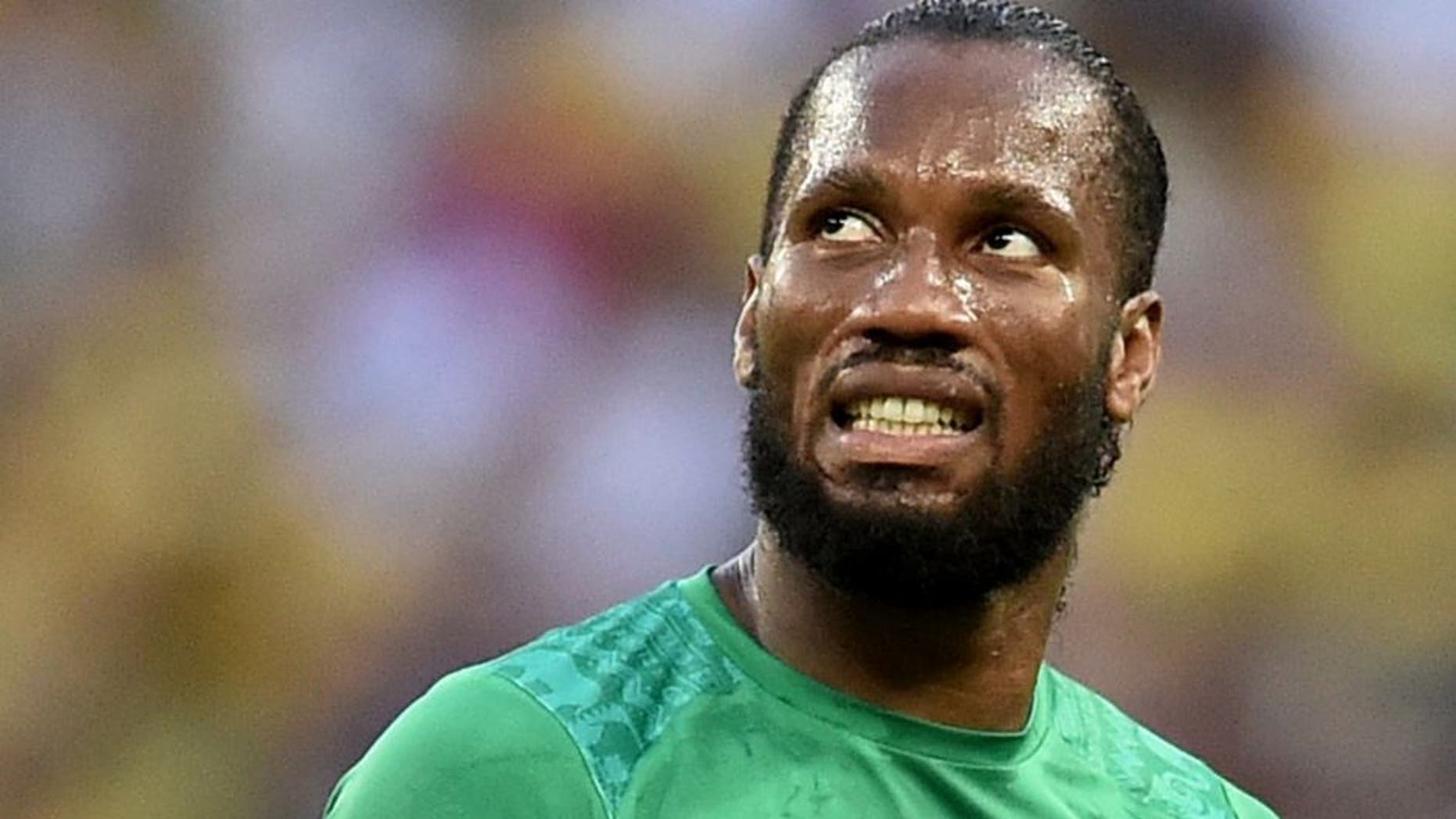 Ivory Coast's forward and captain Didier Drogba reacts during a Group C football match between Greece and Ivory Coast at the Castelao Stadium in Fortaleza during the 2014 FIFA World Cup on June 24, 2014. AFP PHOTO / ARIS MESSINIS