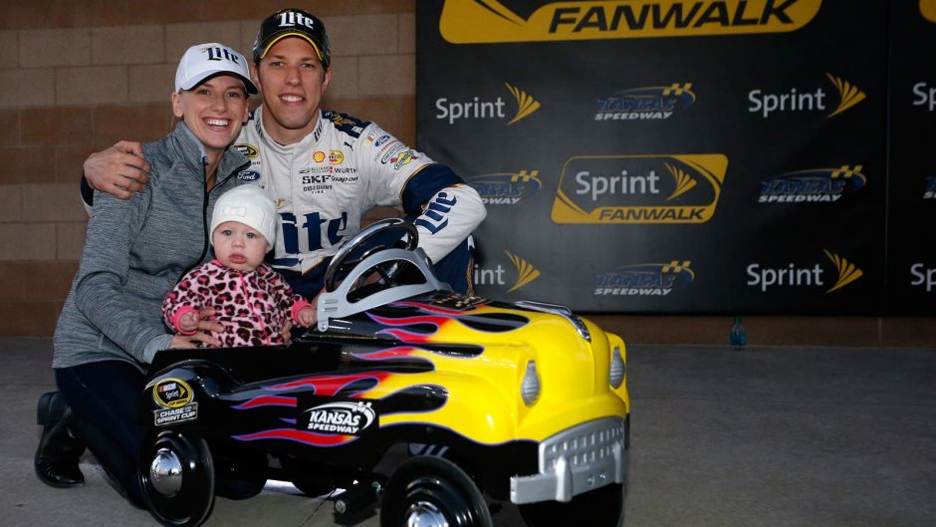 KANSAS CITY, KS - OCTOBER 16: Brad Keselowski, driver of the #2 Miller Lite Ford, poses with his girlfriend Paige White and their daughter Scarlett after Keselowski qualified on the pole for the NASCAR Sprint Cup Series Hollywood Casino 400 at Kansas Speedway on October 16, 2015 in Kansas City, Kansas. (Photo by Brian Lawdermilk/NASCAR via Getty Images)