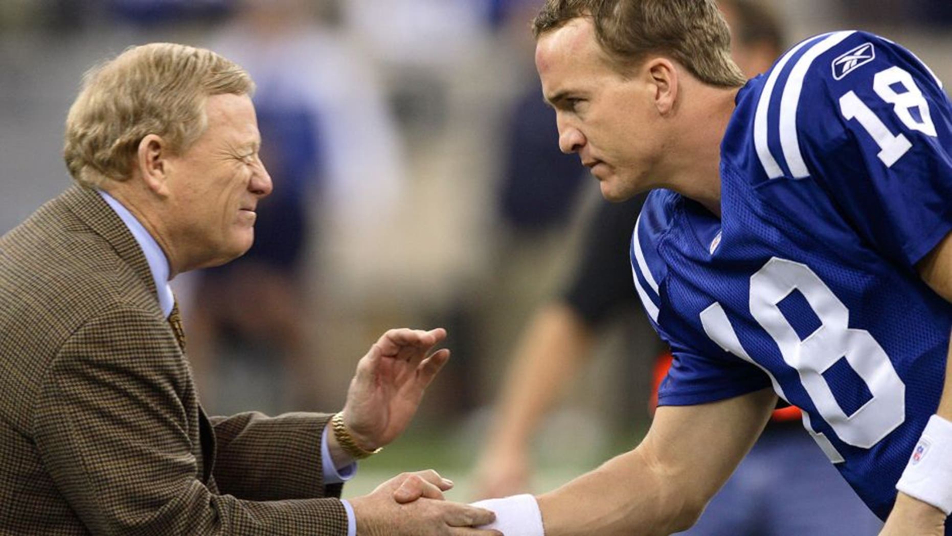 INDIANAPOLIS - JANUARY 21: Peyton Manning #18 of the Indianapolis Colts is greeted by Bill Polian the team's president before the AFC Championship game against the New England Patriots at the RCA Dome on January 21, 2007 in Indianapolis, Indiana. The Colts defeated the Patriots 38-34. (Photo by Joe Robbins/Getty Images)