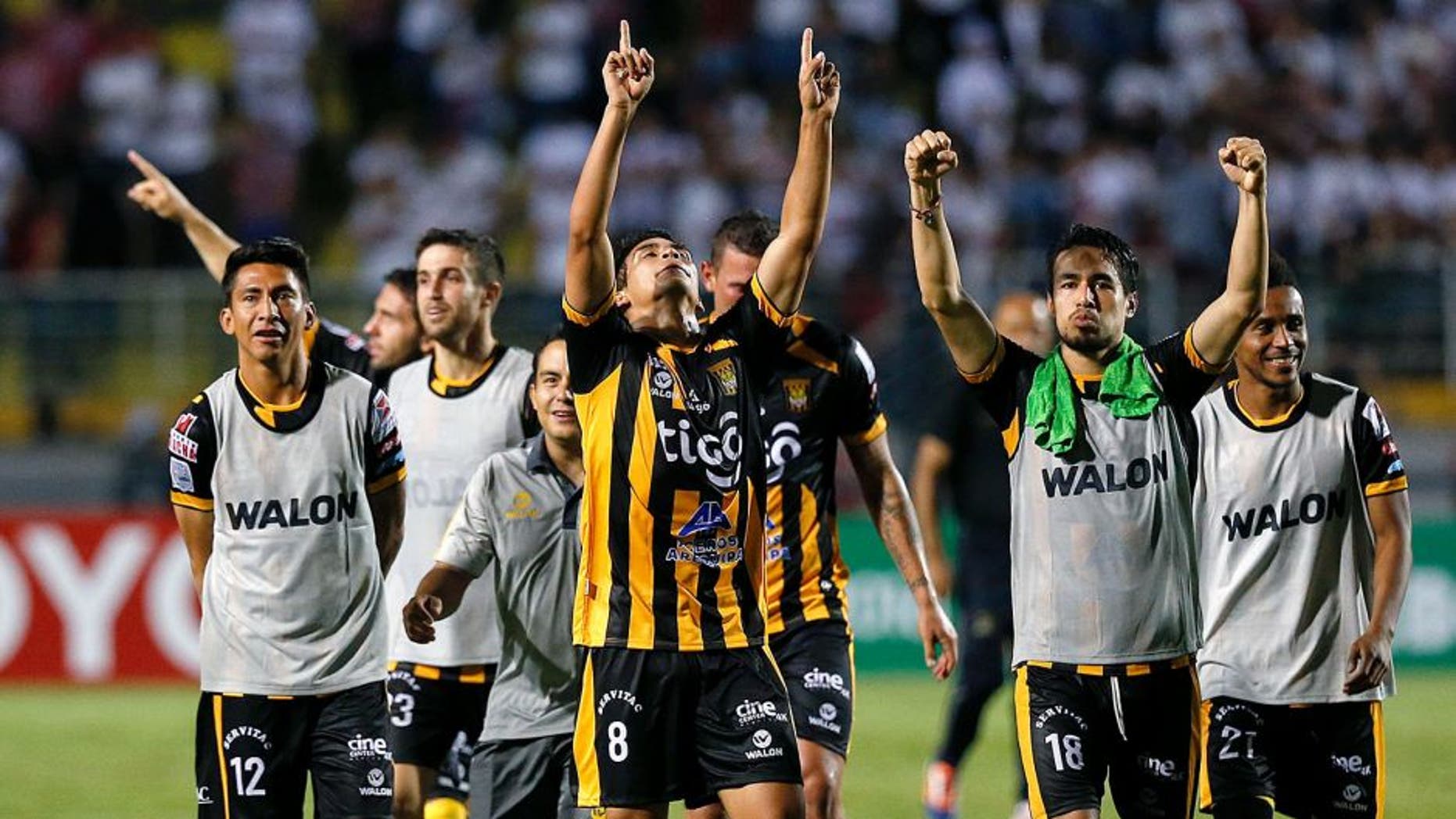Players of Bolivia's The Strongest celebrate winning their Copa Libertadores soccer match against Brazil's Sao Paulo FC in Sao Paulo, Brazil, Wednesday, Feb. 17, 2016. (AP Photo/Andre Penner)