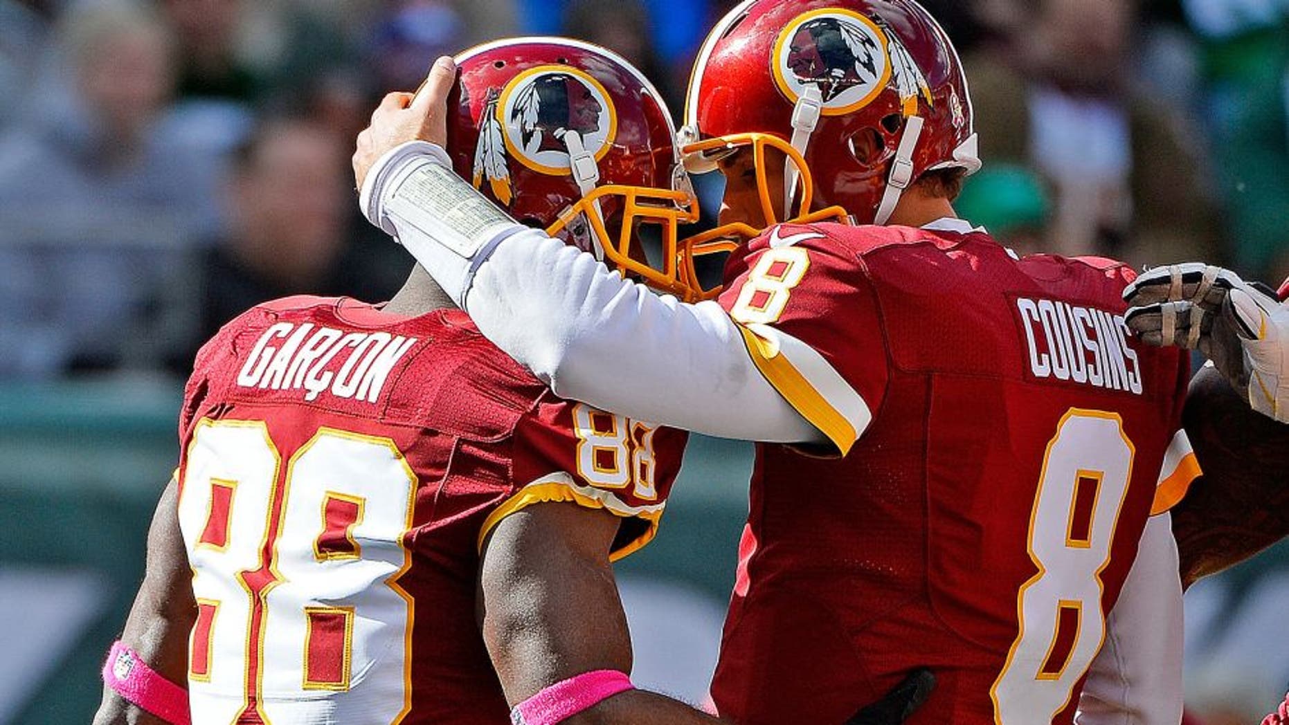 EAST RUTHERFORD, NJ - OCTOBER 18: Pierre Garcon #88 of the Washington Redskins is congratulated by his teammate Kirk Cousins #8 after scoring a first quarter touchdown at MetLife Stadium on October 18, 2015 in East Rutherford, New Jersey. (Photo by Alex Goodlett/Getty Images)