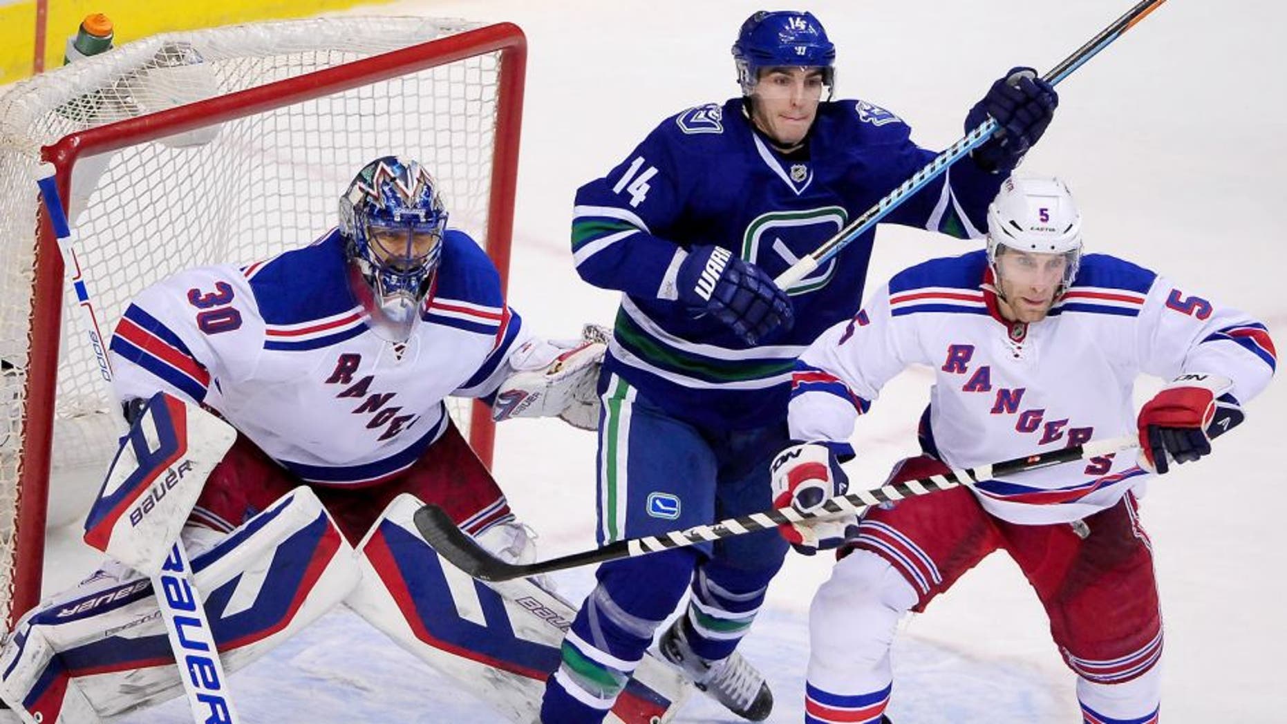 Dec 13, 2014; Vancouver, British Columbia, CAN; Vancouver Canucks forward Alexandre Burrows (14) gets between New York Rangers goaltender Henrik Lundqvist (30) and defenseman Dan Girardi (5) during the third period at Rogers Arena. The New York Rangers won 5-1. Mandatory Credit: Anne-Marie Sorvin-USA TODAY Sports