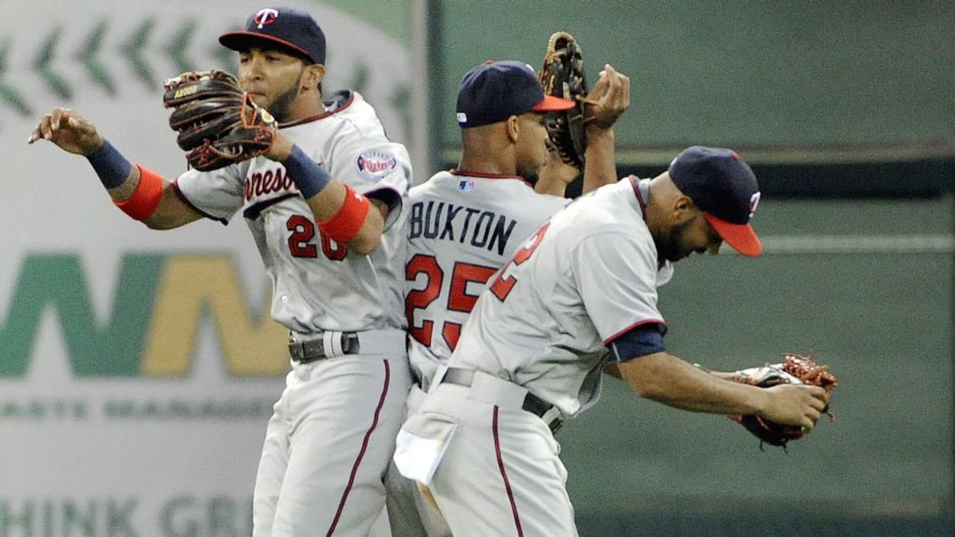 HOUSTON, TX - SEPTEMBER 5: (L TO R) Eddie Rosario, Byron Buxton, and Miguel Sano celebrate the Minnesota Twins' 3-2 victory over the Houston Astros at Minute Maid Park on September 5, 2015 in Houston, Texas. (Photo by Eric Christian Smith/Getty Images)