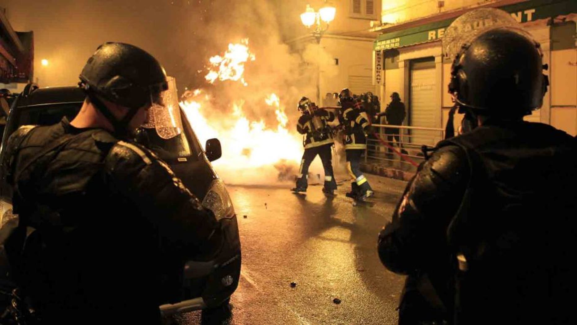 Firefighters try to extinguish a fire during clashes between protesters and police in Corte on the French Mediterranean island of Corsica on February 16, 2016. French club Bastia have "categorically refused" an order by the French Professional League (LFP) to advance the kick-off time of their Ligue 1 game against Nantes on February 20 amid security fears in Corsica. The decision to bring the game forward from 20:00 local time (1900GMT) to 14:00 (1300GMT) was requested by police on the French Mediterranean island after violence sparked by Corsican fans during the league game at Reims on February 13. Fans threw fireworks at police before and after the match in the Champagne region with the violence spilling into the town when a 22-year-old Corsican suffered a serious eye injury while being pursued by police. Fresh clashes erupted on Tuesday when around 50 masked individuals interrupted peaceful demonstrations by throwing Molotov cocktails at police forces, who in turn responded with tear gas to quell the trouble. / AFP / Pascal POCHARD-CASABIANCA (Photo credit should read PASCAL POCHARD-CASABIANCA/AFP/Getty Images)