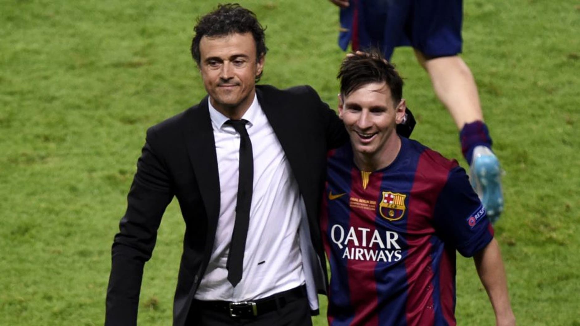 Barcelona's coach Luis Enrique and Barcelona's Argentinian forward Lionel Messi (R) celebrate after winning the UEFA Champions League Final football match between Juventus and FC Barcelona at the Olympic Stadium in Berlin on June 6, 2015. AFP PHOTO / ODD ANDERSEN (Photo credit should read ODD ANDERSEN/AFP/Getty Images)