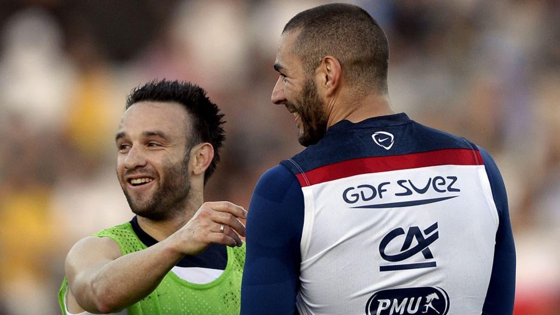 France's midfielder Mathieu Valbuena (L) talks to France's forward Karim Benzema during a training session at the Santa Cruz Stadium in Ribeirao Prato on June 10, 2014, a few days prior to the start of the 2014 FIFA World Cup in Brazil. AFP PHOTO / FRANCK FIFE (Photo credit should read FRANCK FIFE/AFP/Getty Images)