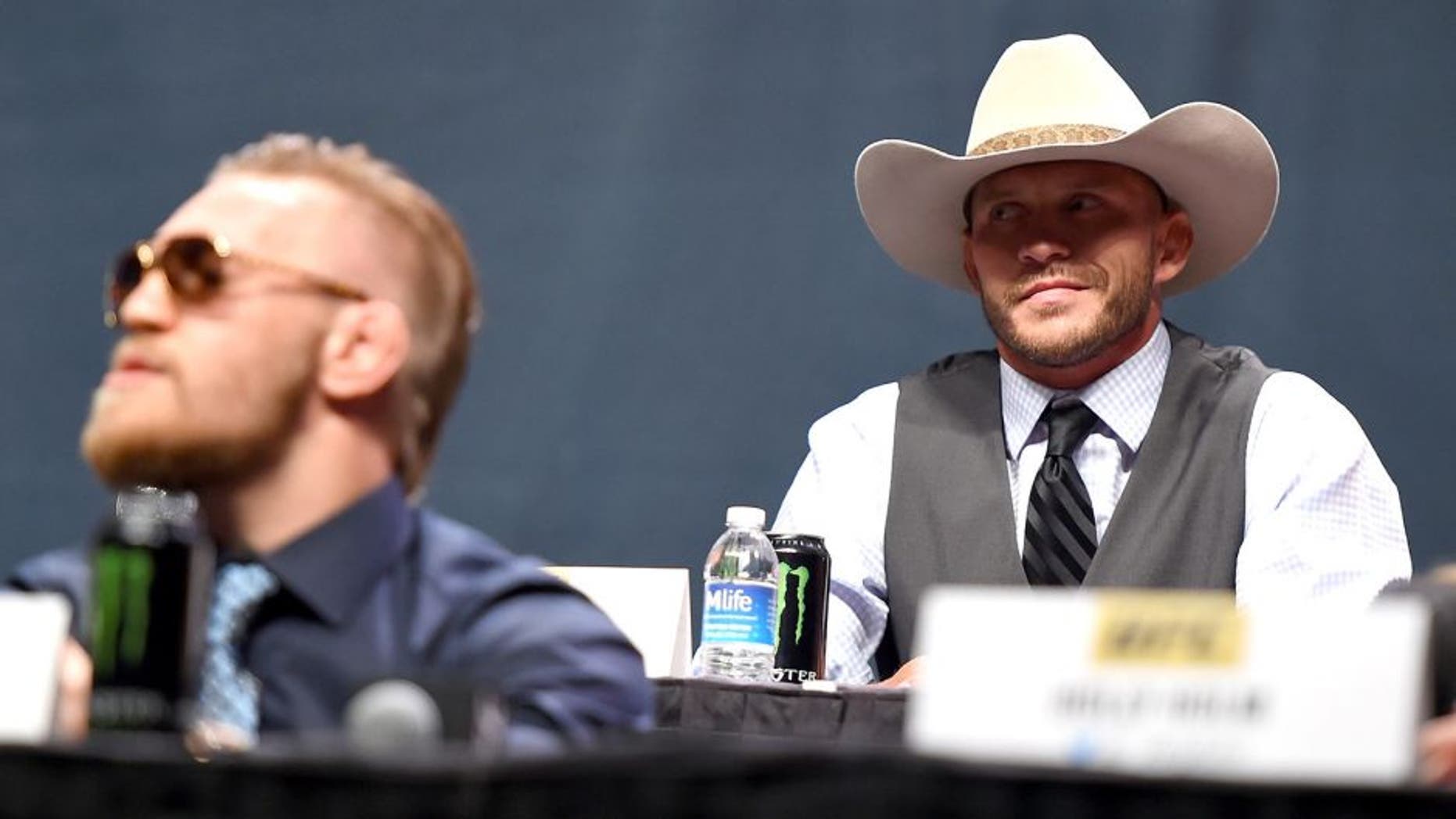 LAS VEGAS, NEVADA - SEPTEMBER 04: (R-L) UFC lightweight title challenger Donald 'Cowboy' Cerrone exchanges words with UFC interim featherweight champion Conor McGregor during the UFC's Go Big launch event inside MGM Grand Garden Arena on September 4, 2015 in Las Vegas, Nevada. (Photo by Jeff Bottari/Zuffa LLC/Zuffa LLC via Getty Images)