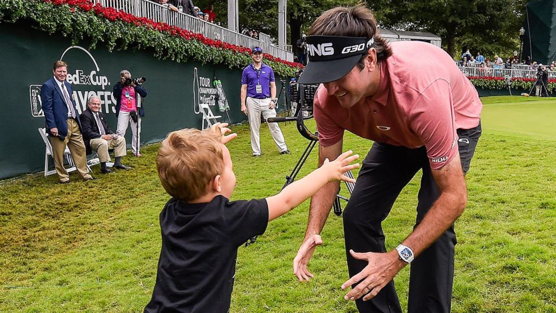 ATLANTA, GA - SEPTEMBER 27: Bubba Watson hugs his son Caleb on the 18th hole green following the final round of the TOUR Championship by Coca-Cola, the final event of the FedExCup Playoffs, at East Lake Golf Club on September 27, 2015 in Atlanta, Georgia. (Photo by Stan Badz/PGA TOUR)