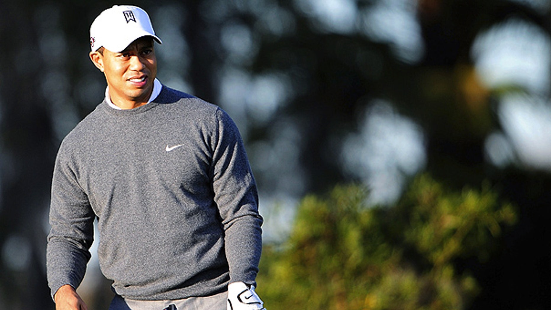 File: Tiger Woods practices golf outside his home in Windermere, Fla.