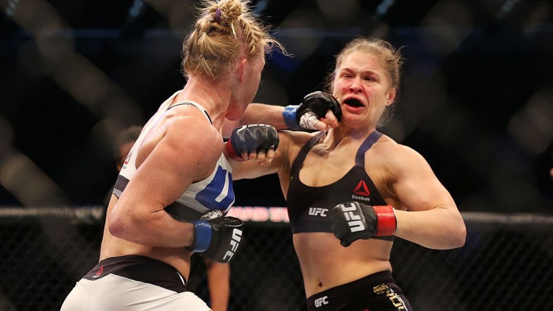 MELBOURNE, AUSTRALIA - NOVEMBER 15: Ronda Rousey of the United States (R) and Holly Holm of the United States compete in their UFC women's bantamweight championship bout during the UFC 193 event at Etihad Stadium on November 15, 2015 in Melbourne, Australia. (Photo by Quinn Rooney/Getty Images)