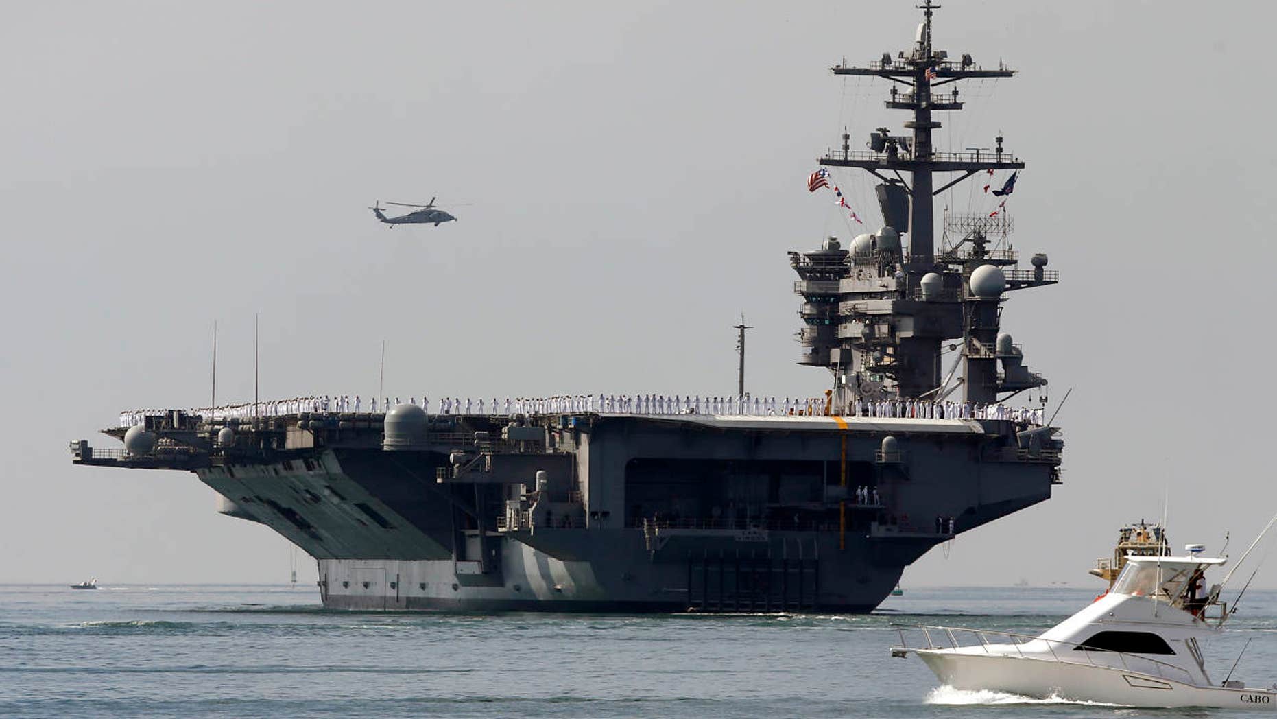 FILE - In this Aug. 22, 2014 file photo, the aircraft carrier USS Carl Vinson sails out of San Diego Harbor leaving for a nine month deployment in San Diego.