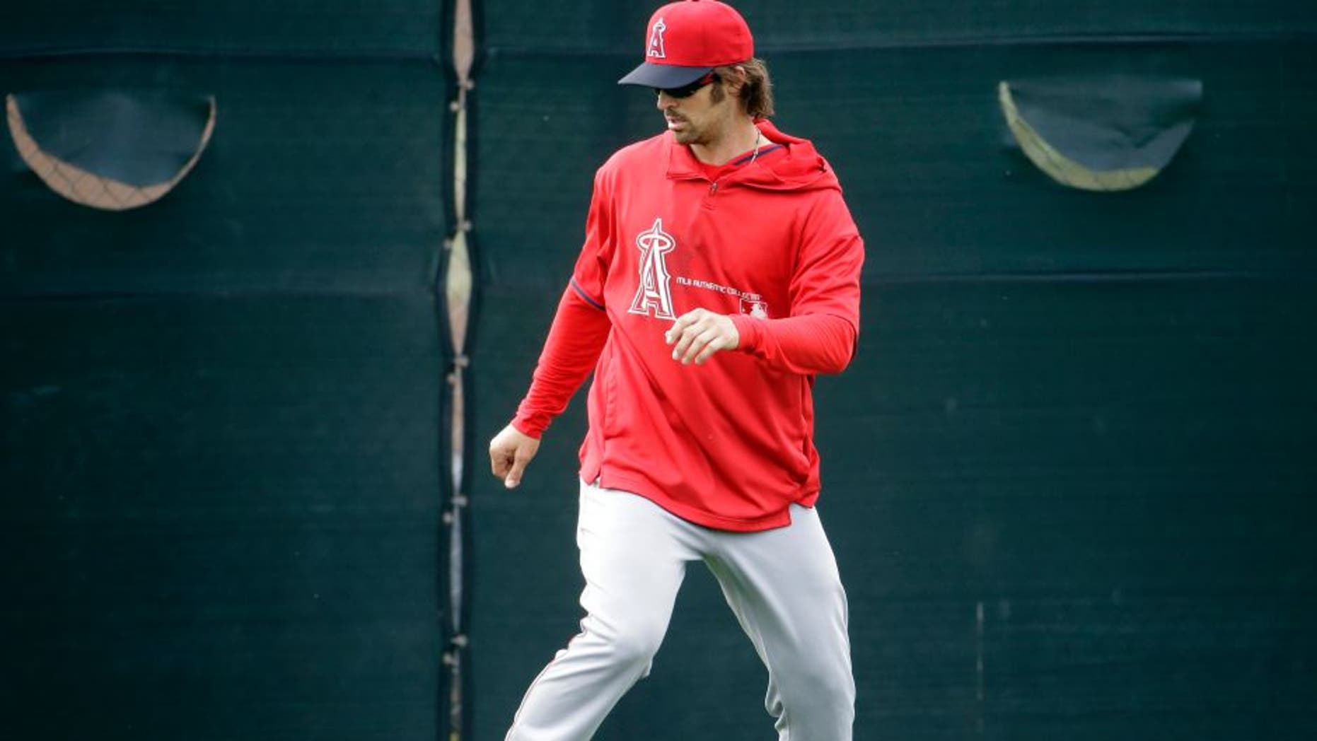 Los Angeles Angels C.J. Wilson warms up during a spring training baseball workout Friday, Feb. 20, 2015, in Tempe, Ariz. (AP Photo/Morry Gash)
