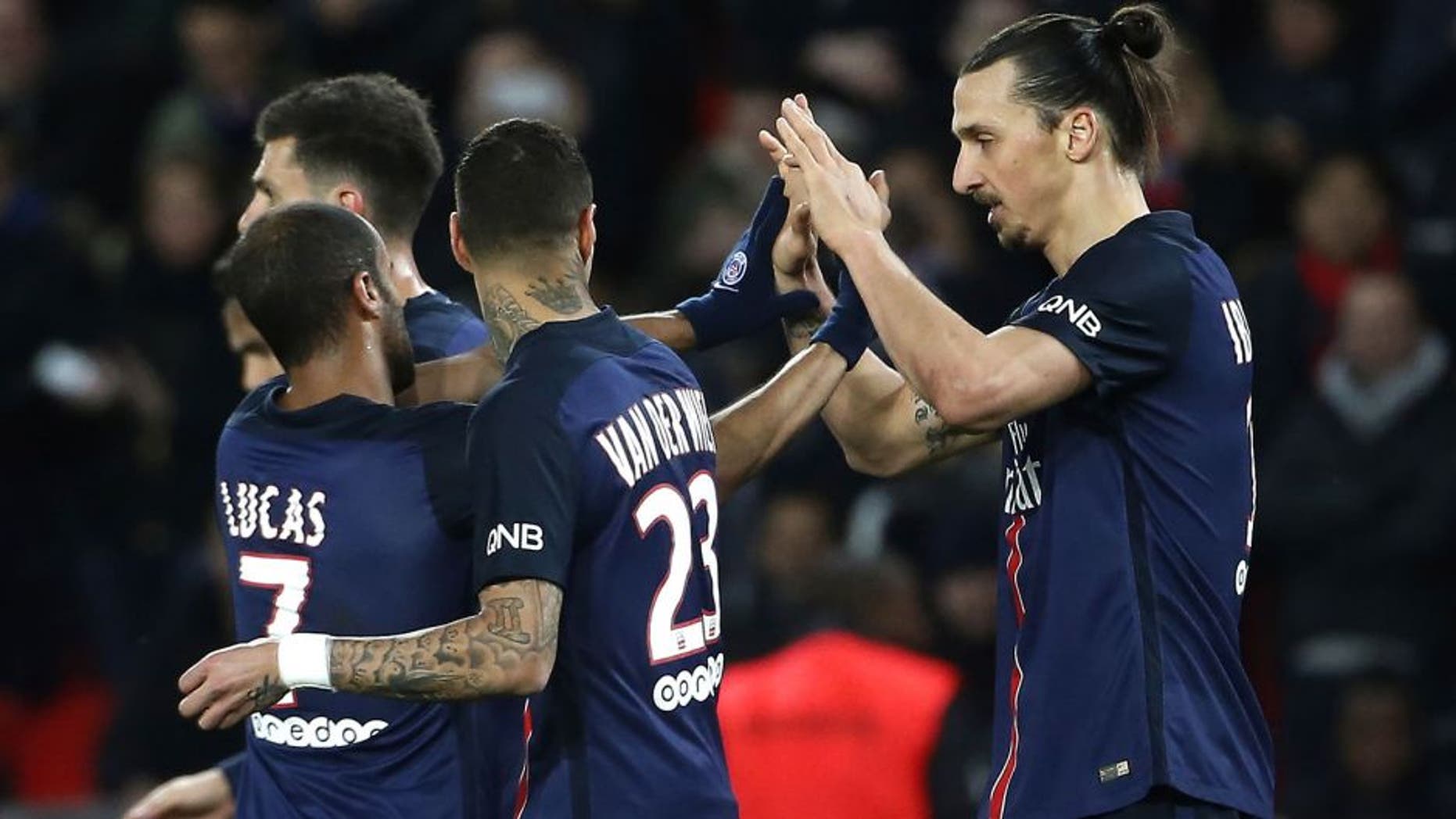 Paris Saint-Germain's Swedish forward Zlatan Ibrahimovic (R) celebrates with teammates after scoring a goal during the French L1 football match between Paris Saint-Germain (PSG) and Reims at the Parc des Princes stadium in Paris on February 20, 2016. AFP PHOTO / THOMAS SAMSON / AFP / THOMAS SAMSON (Photo credit should read THOMAS SAMSON/AFP/Getty Images)