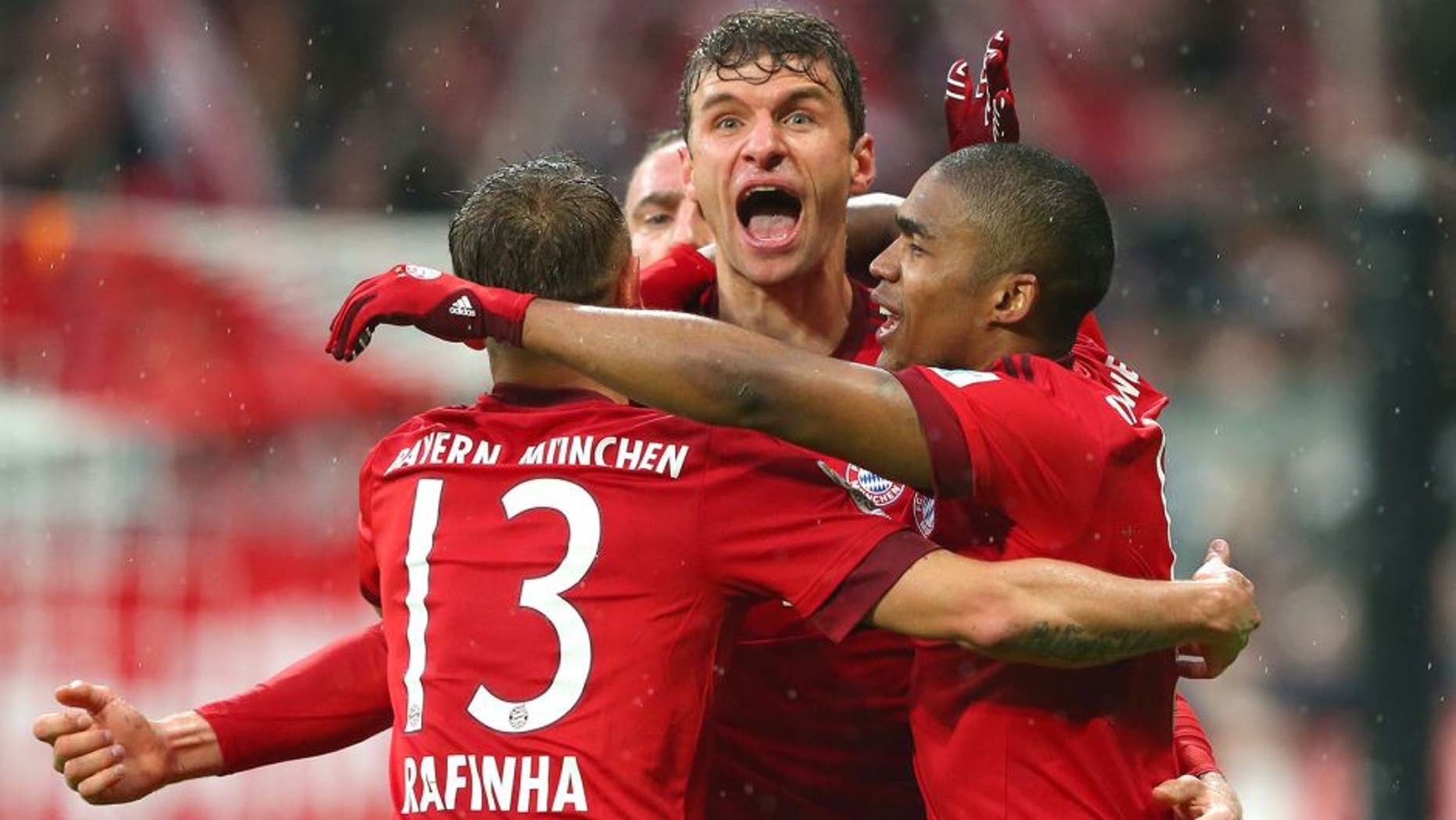 MUNICH, GERMANY - FEBRUARY 20: Thomas Mueller (C) of Muenchen celebrates scoring the 2nd team goal with his team mates Rafinha (L) and Douglas Costa during the Bundesliga match between FC Bayern Muenchen and SV Darmstadt 98 at Allianz Arena on February 20, 2016 in Munich, Germany. (Photo by A. Hassenstein/Getty Images for FC Bayern)