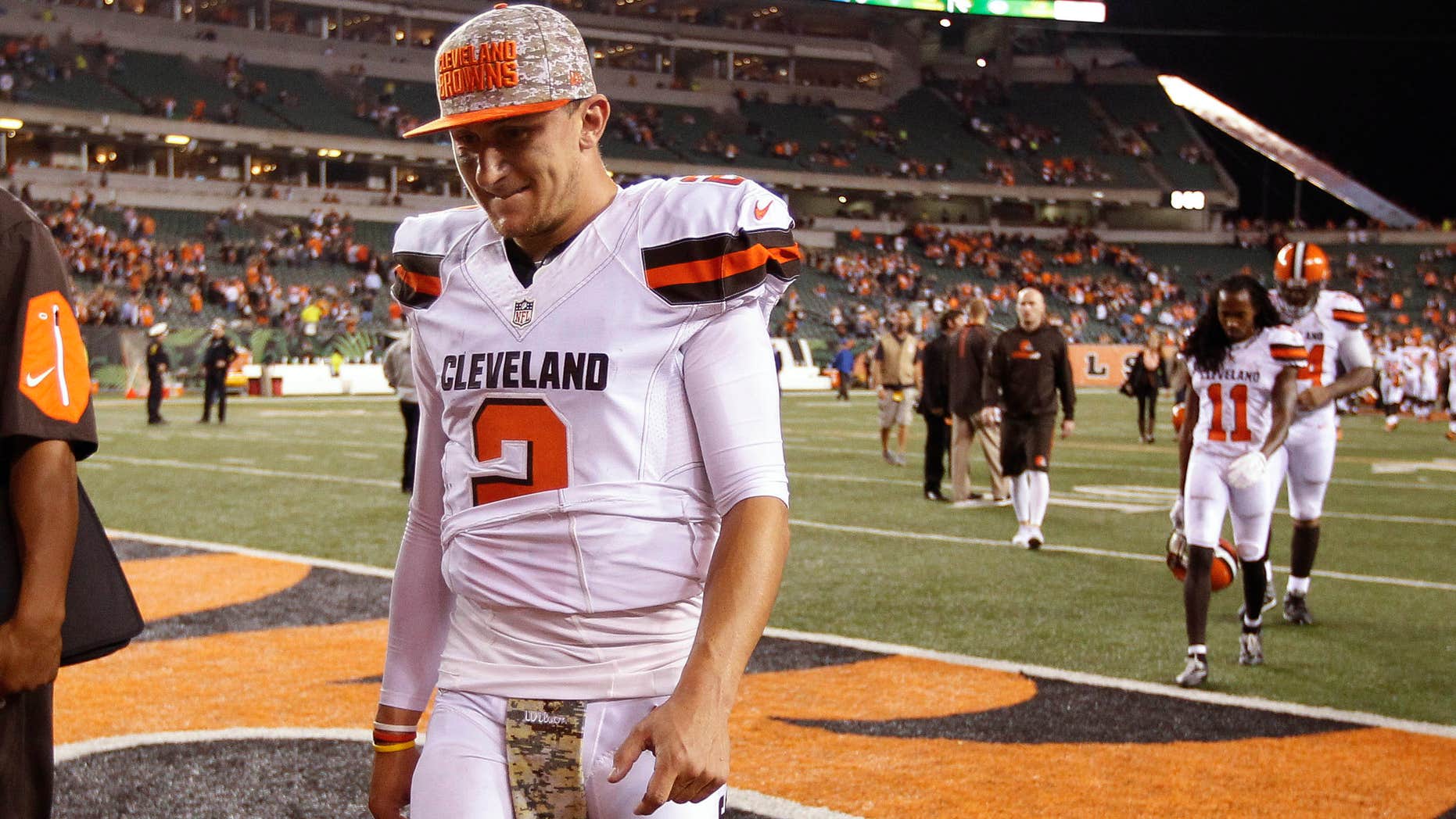 FILE- In this Nov. 5, 2015, file photo, Cleveland Browns quarterback Johnny Manziel walks off the field after the Browns lost 31-10 to the Cincinnati Bengals during an NFL football game in Cincinnati.