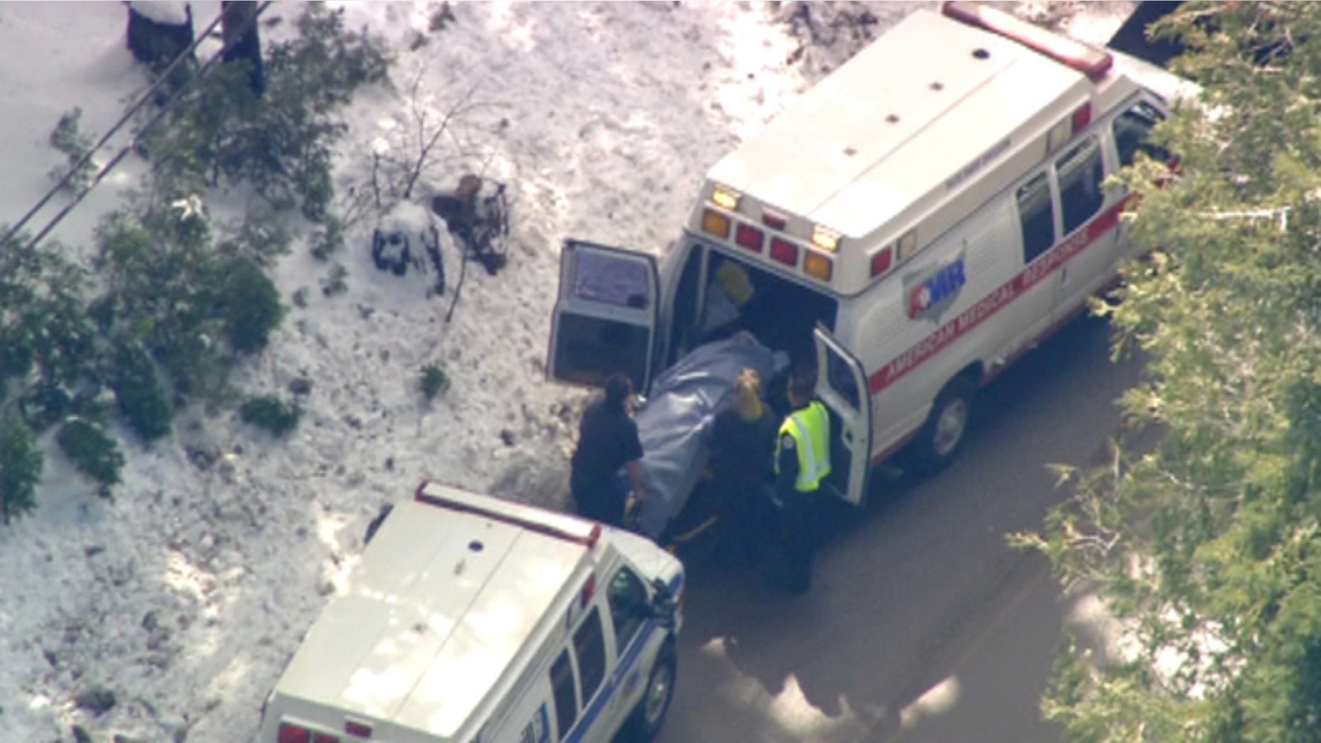 Feb. 21: An injured victim from a school bus accident is loaded into the back of an ambulance.