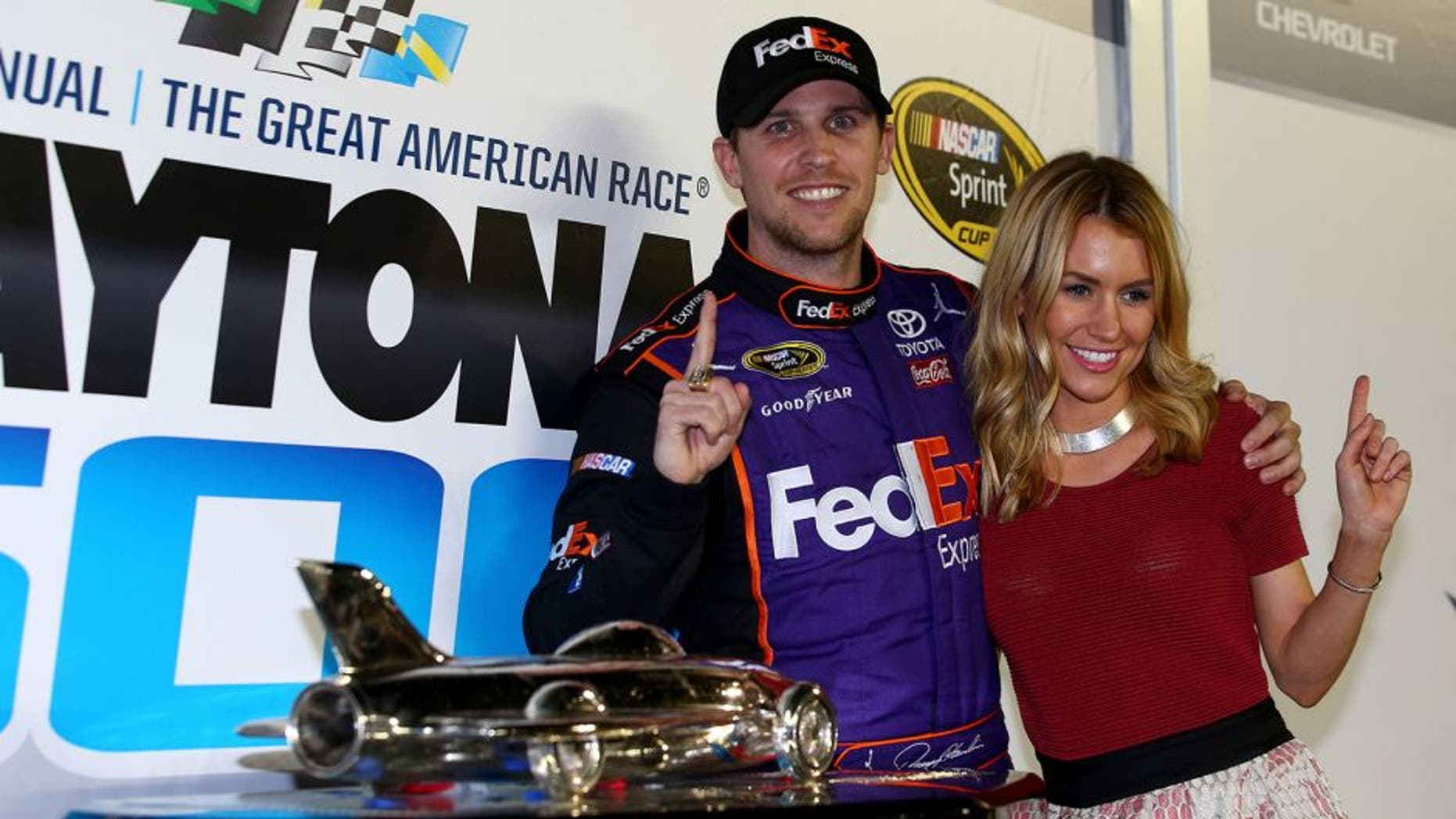 DAYTONA BEACH, FL - FEBRUARY 21: Denny Hamlin, driver of the #11 FedEx Express Toyota, celebrates in Victory Lane with his wife, Jordan Fish after winning the NASCAR Sprint Cup Series DAYTONA 500 at Daytona International Speedway on February 21, 2016 in Daytona Beach, Florida. (Photo by Sarah Crabill/NASCAR via Getty Images)