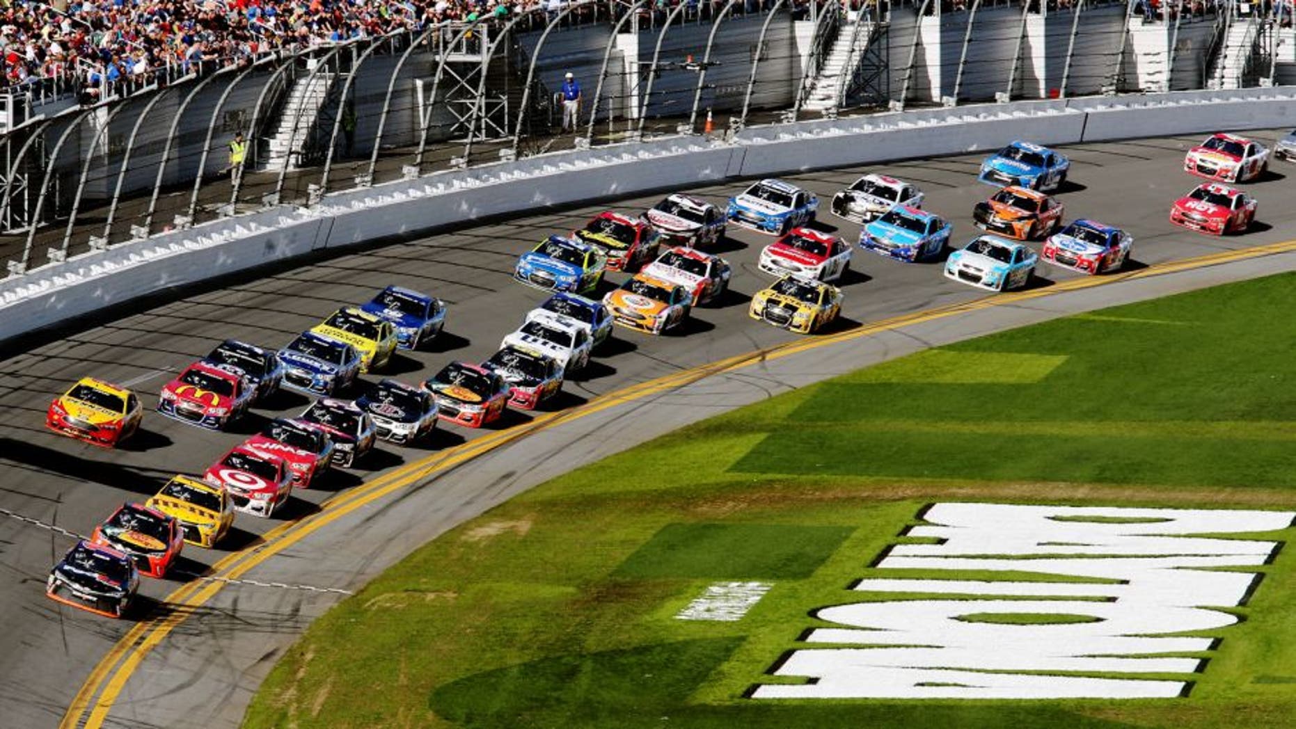 DAYTONA BEACH, FL - FEBRUARY 21: Denny Hamlin, driver of the #11 FedEx Express Toyota, leads the field during the NASCAR Sprint Cup Series DAYTONA 500 at Daytona International Speedway on February 21, 2016 in Daytona Beach, Florida. (Photo by Jerry Markland/Getty Images)