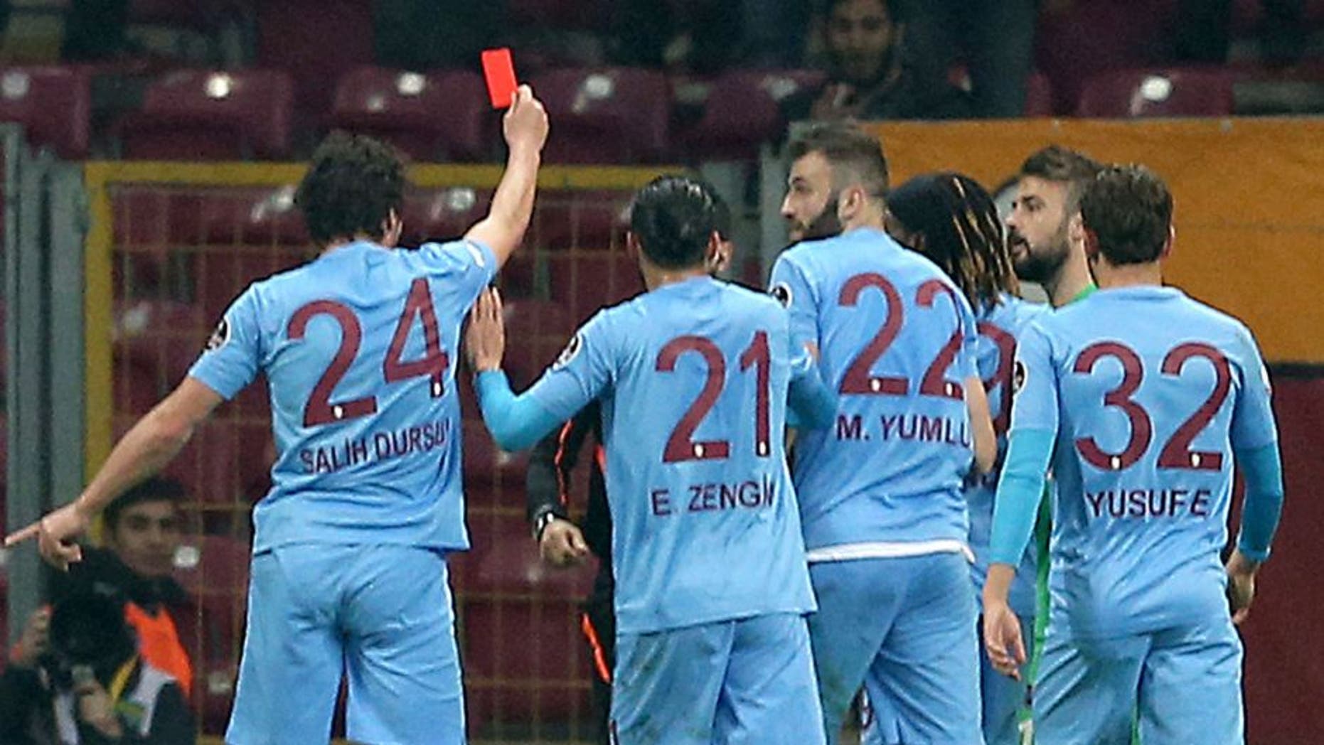 ISTANBUL, TURKEY, FEBRUARY 21: Salih Dursun (24) of Trabzonspor shows a red card to referee as he takes the card from referee's hand to react his decisions during Turkish Spor Toto Super Lig football match between Galatasaray and Trabzon at Turk Telekom Arena in Istanbul, Turkey on February 21, 2016. (Photo by Berk Ozkan/Anadolu Agency/Getty Images)