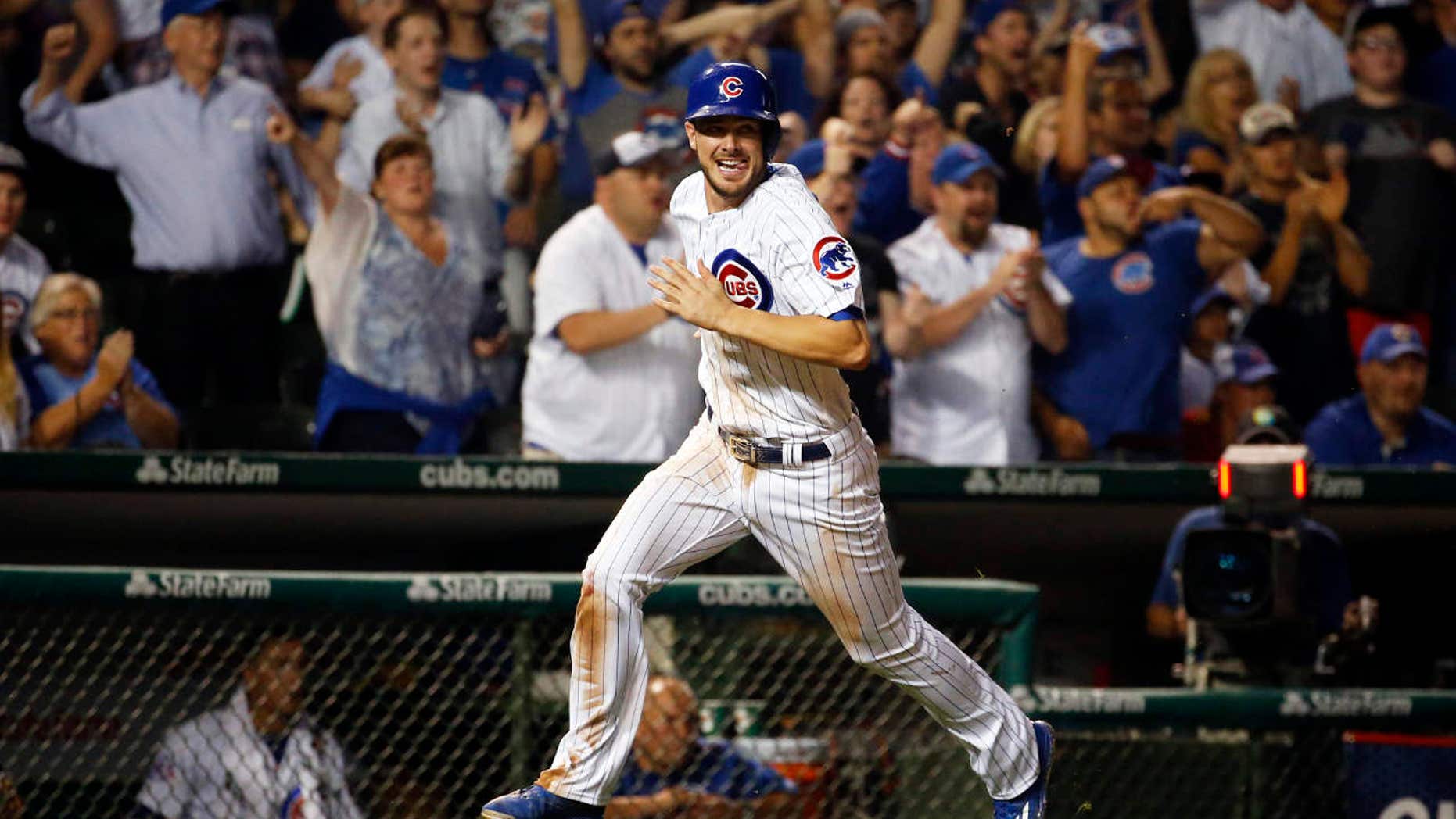 FILE - In this July 7, 2016, file photo, Chicago Cubs' Kris Bryant scores on a single hit by Ben Zobrist during the eighth inning of a baseball game against the Atlanta Braves, in Chicago.