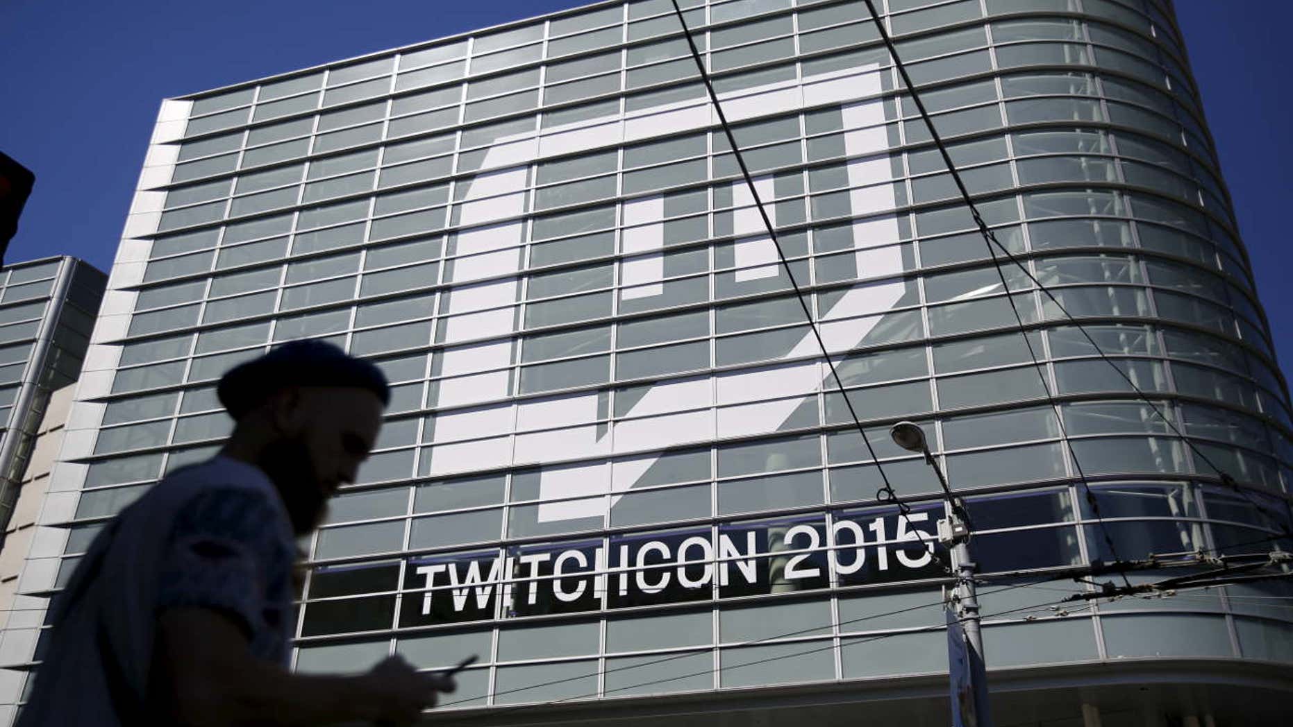 Sept. 25, 2015: A man works with a mobile device prior to entering TwitchCon 2015 in San Francisco.