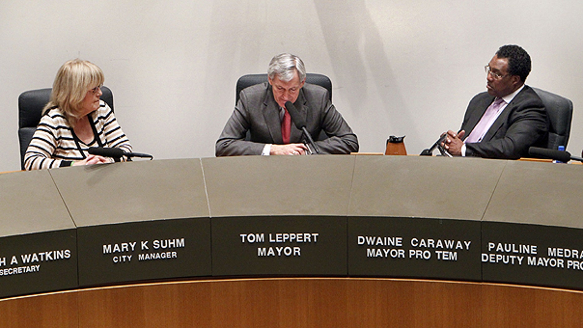 Feb. 23: Dallas City Manager Mary Suhm, left, and Dallas Mayor Pro Tem Dwaine Caraway, right, listen as Dallas Mayor Tom Leppert pauses during his resignation address.