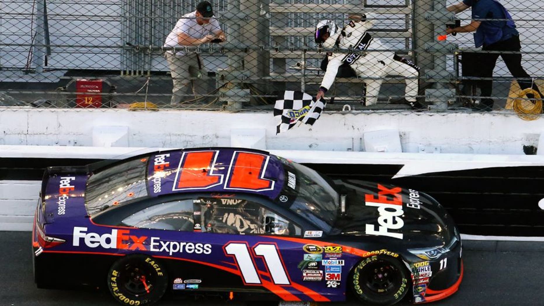 Danny Hamlin picks up the checkered flag after winning the Daytona 500 at Daytona International Speedway in Daytona Beach, Fla., on Sunday, Feb. 21, 2016. (Joe Burbank/Orlando Sentinel/TNS via Getty Images)