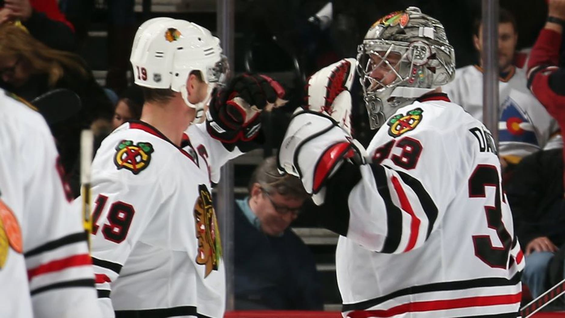 NEWARK, NJ - DECEMBER 09: Jonathan Toews #19 and Scott Darling #33 of the Chicago Blackhawks celebrate a 3-2 shootout victory over the New Jersey Devils at the Prudential Center on December 9, 2014 in Newark, New Jersey. (Photo by Bruce Bennett/Getty Images)
