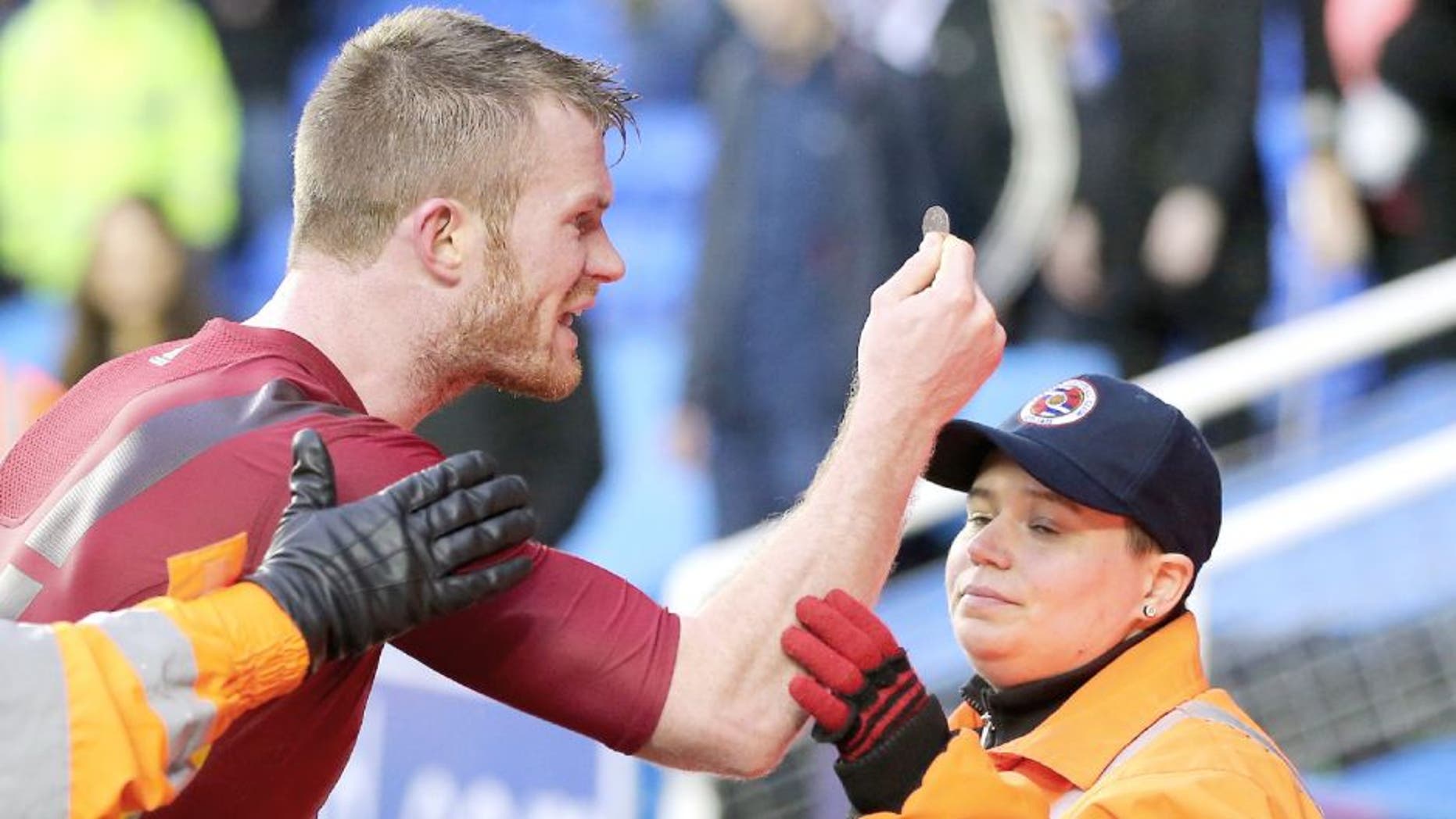 READING, ENGLAND - FEBRUARY 20: Chris Brunt of West Bromwich Albion is held back by stewards as he holds up the coin that was thrown at him by his own supporters after the Emirates FA Cup match between Reading and West Bromwich Albion at Madejski Stadium on February 20, 2016 in Reading, England. (Photo by Adam Fradgley - AMA/ Getty Images)