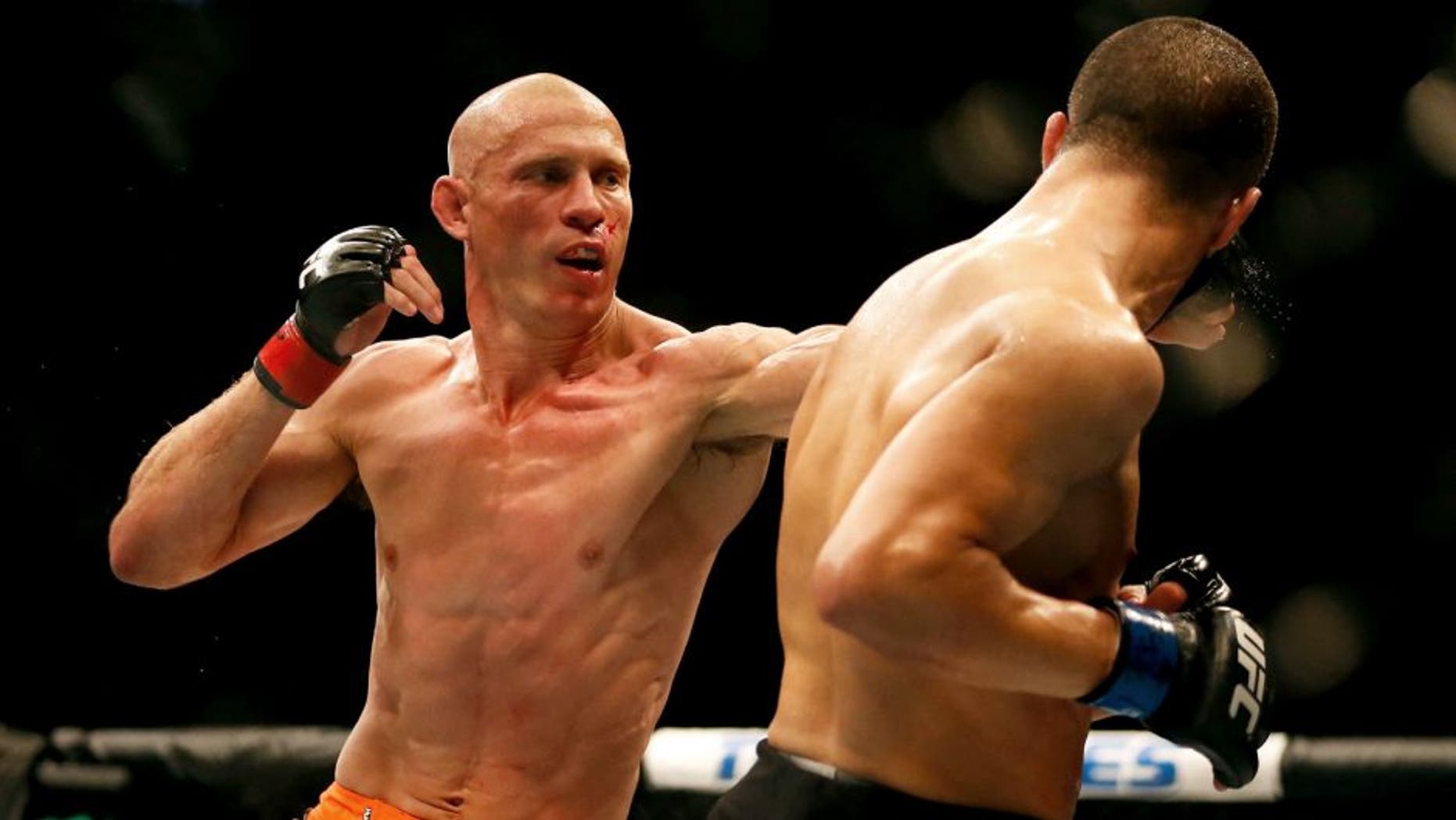 LAS VEGAS, NV - MAY 23: (L-R) Donald Cerrone punches John Makdessi of Canada in their lightweight bout during the UFC 187 event at the MGM Grand Garden Arena on May 23, 2015 in Las Vegas, Nevada. (Photo by Christian Petersen/Zuffa LLC/Zuffa LLC via Getty Images)