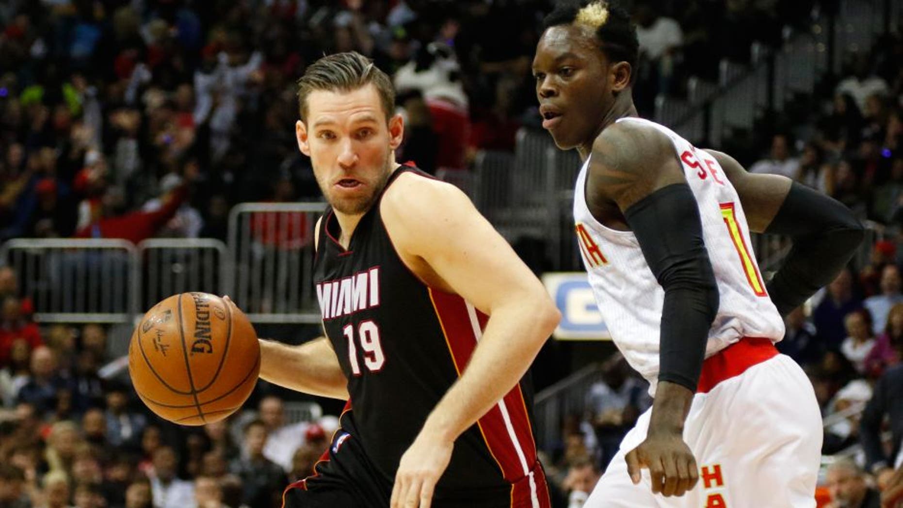 Feb 19, 2016; Atlanta, GA, USA; Miami Heat guard Beno Udrih (19) drives past Atlanta Hawks guard Dennis Schroder (17) in the fourth quarter at Philips Arena. The Heat defeated the Hawks 115-111. Mandatory Credit: Brett Davis-USA TODAY Sports