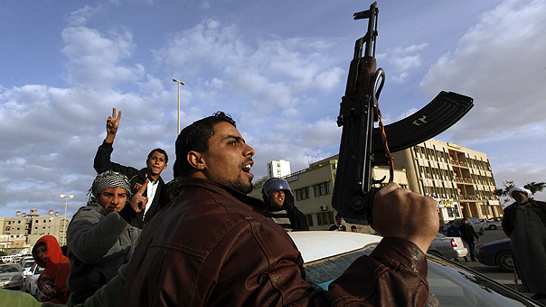 Feb. 23: A Libyan protester holds a weapon as he shouts slogans against Libyan Leader Muammar Qaddafi, during a demonstration in Tobruk, Libya.