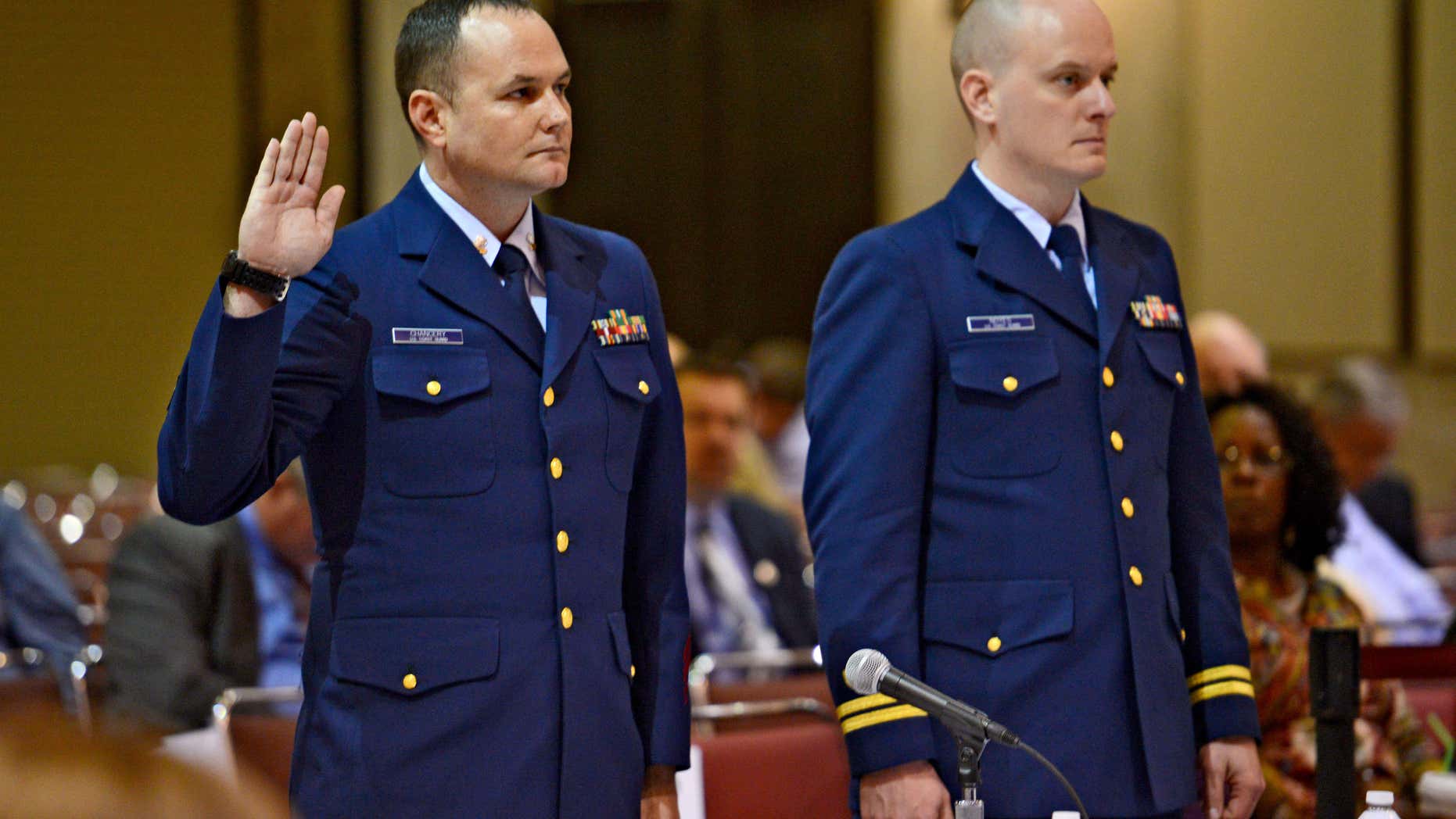 Feb. 24, 2016: OS2 Matthew Chancery, left, U.S. Coast Guard District 7, is sworn in to start the day while standing next to his counsel Lt. Travis Noyes as a U.S. Coast Guard investigative hearing into the sinking of the El Faro continues in Jacksonville, Fla..