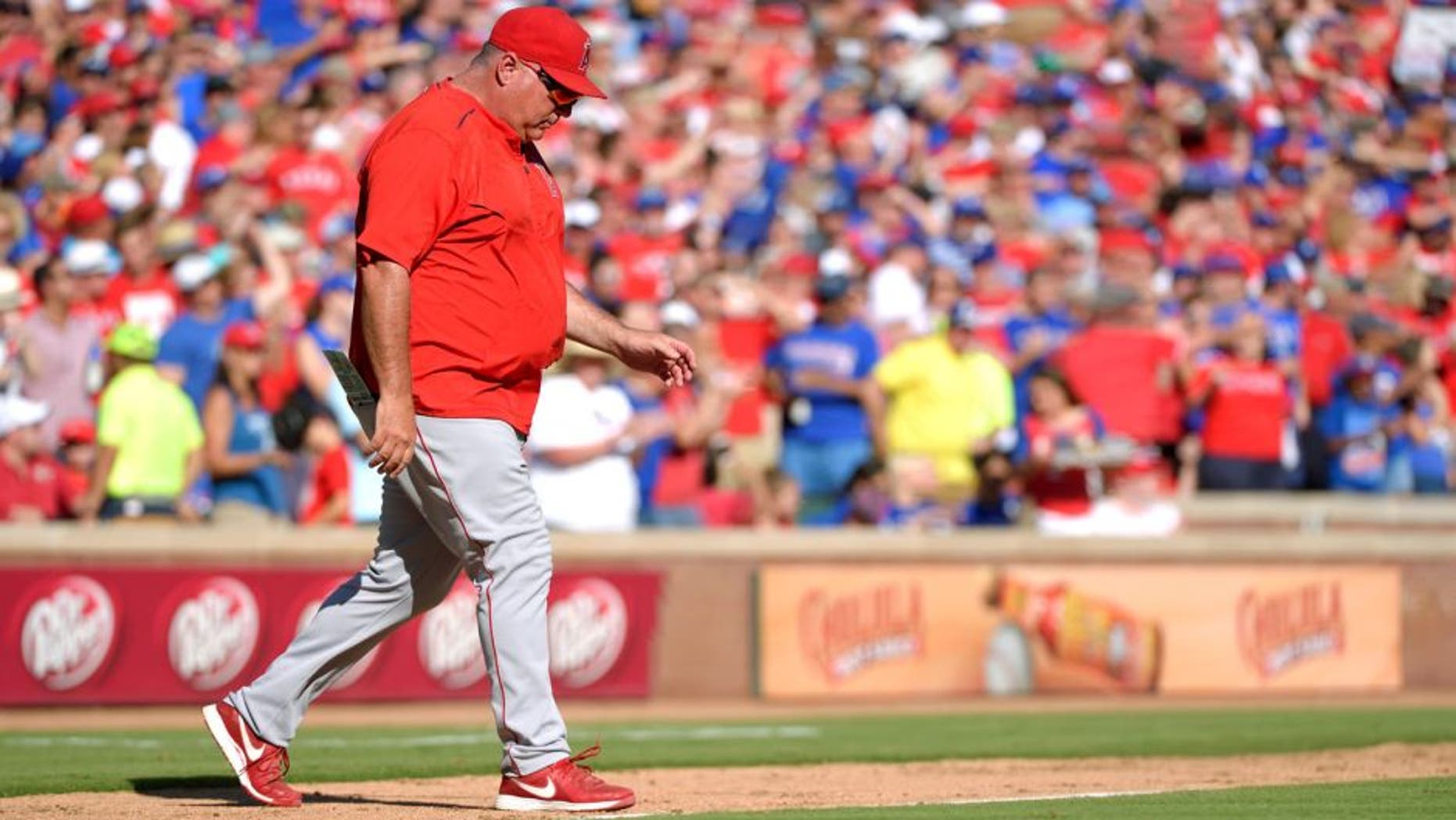 ARLINGTON, TX - OCTOBER 4: Manager Mike Scioscia #14 of the Los Angeles Angels of Anaheim makes a visit to the mound during the seventh inning of the game against the Texas Rangers at Globe Life Park in Arlington on October 4, 2015 in Arlington, California. (Photo by Matt Brown/Angels Baseball LP/Getty Images)