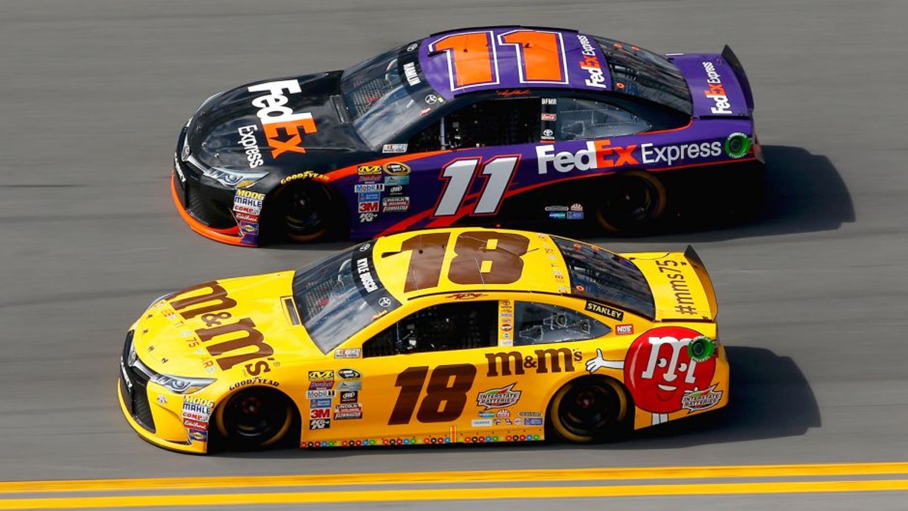 DAYTONA BEACH, FL - FEBRUARY 21: Kyle Busch, driver of the #18 M&M's 75 Toyota, races Denny Hamlin, driver of the #11 FedEx Express Toyota, during the NASCAR Sprint Cup Series DAYTONA 500 at Daytona International Speedway on February 21, 2016 in Daytona Beach, Florida. (Photo by Jonathan Ferrey/Getty Images)