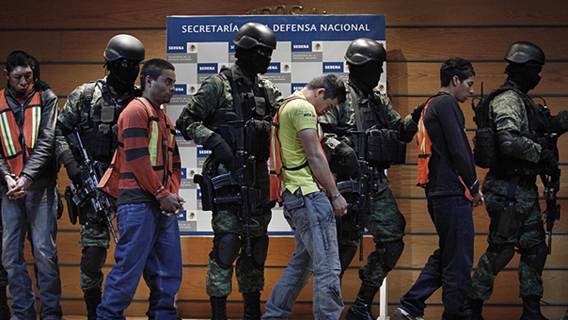 Feb. 23: Soldiers escort Julian Zapata Espinosa, aka 'El Piolin,' fourth right, alleged member of the Los Zetas drug cartel and main suspect in the killing of U.S. Immigration and Customs, ICE, agent Jaime Zapata.