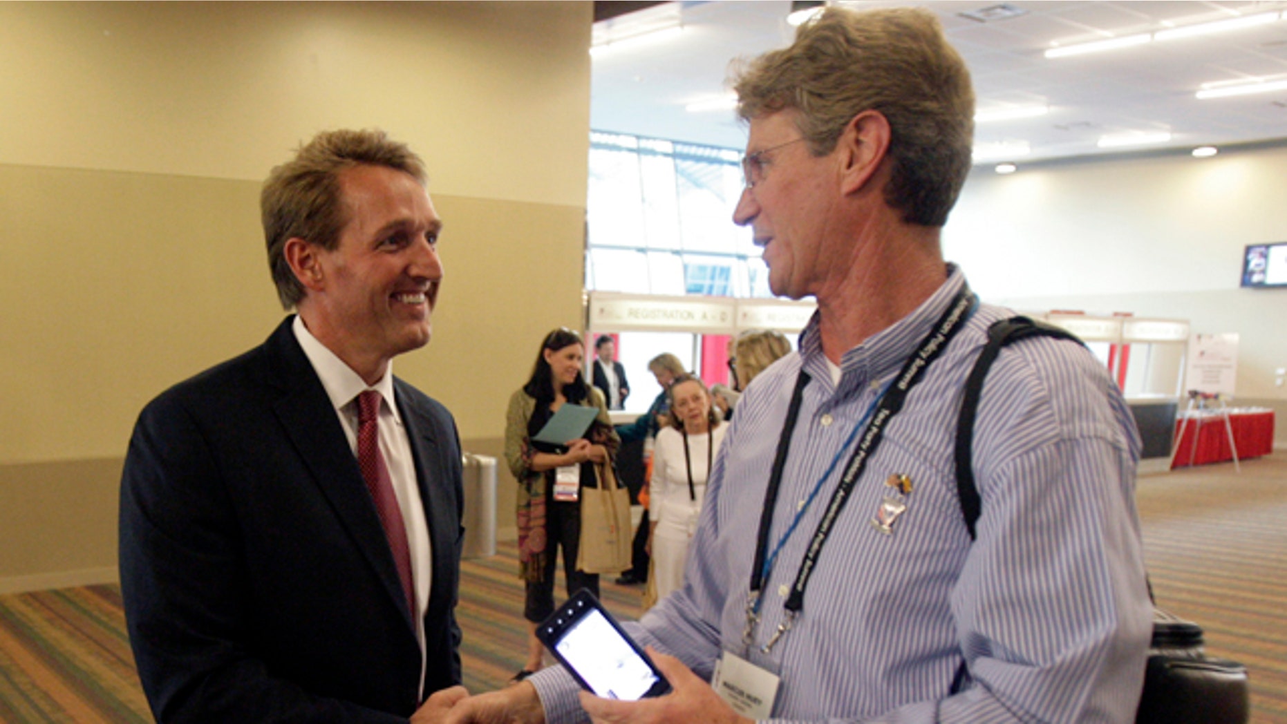 Feb. 25: Rep. Jeff Flake (R-Ariz.), left, is greeted by Marcus Huey, right, of Tea Party Patriots of Glendale, Ariz., as Flake arrives to hear keynote speakers on the opening day of the Tea Party's convention.