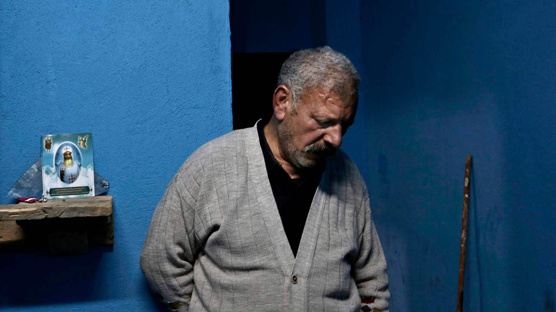 Egyptian Christian Ezzat Yaacoub Ishak, who fled el-Arish in North Sinai with his family two days ago due to fighting, stands in his newly rented apartment, in Ismailia, 120 kilometers (75 miles) east of Cairo, Egypt, Sunday, Feb. 26, 2017.