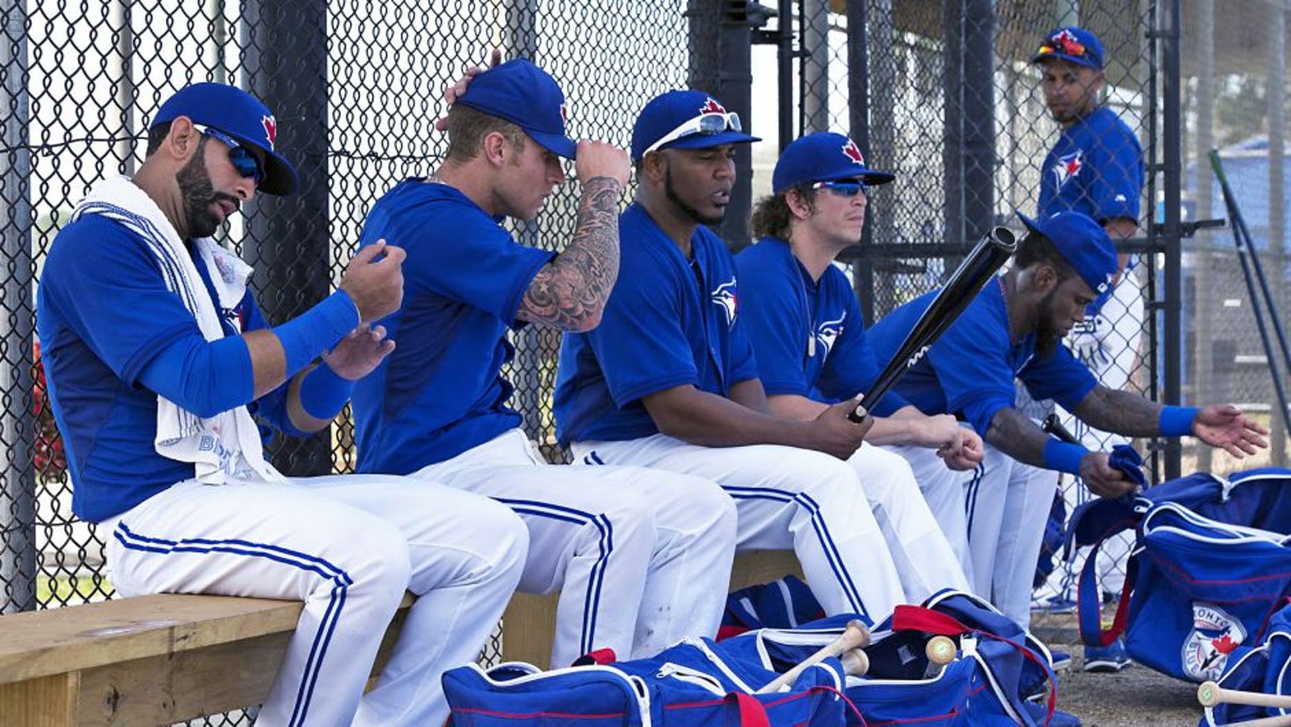 Toronto Blue Jays, from left, Jose Bautista, Brett Lawrie, Edwin Encarnacion, Colby Rasmus and Jose Reyes prepare for an intrasquad game at baseball spring training in Dunedin, Fla., Tuesday, Feb. 25, 2014. (AP Photo/The Canadian Press, Frank Gunn)